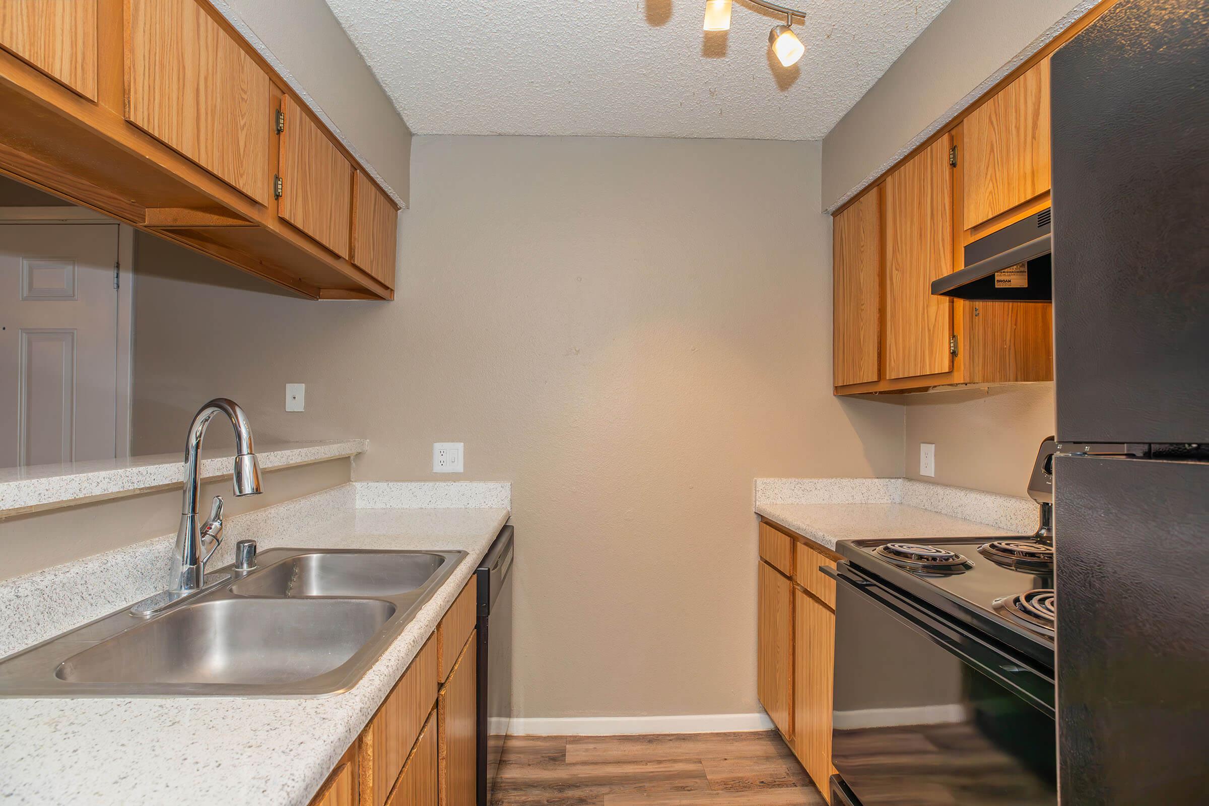 a kitchen with stainless steel appliances and wooden cabinets