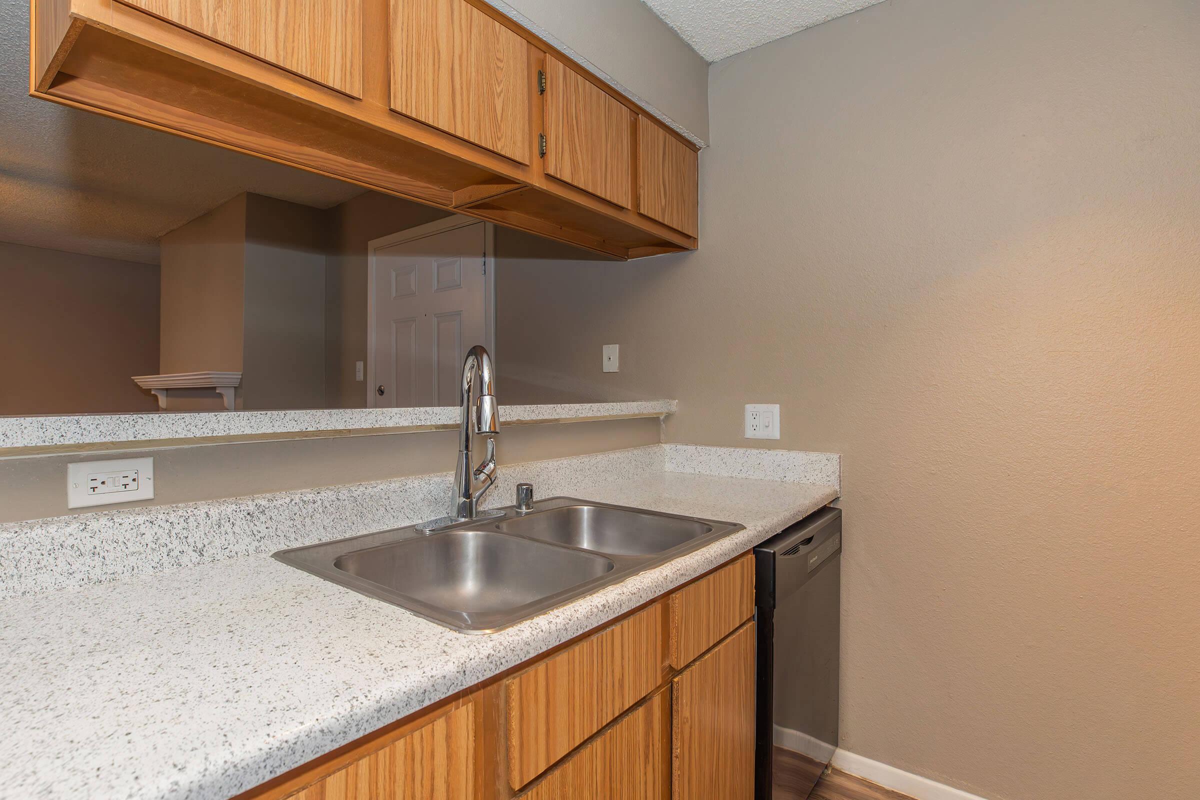 a kitchen with a sink and a mirror