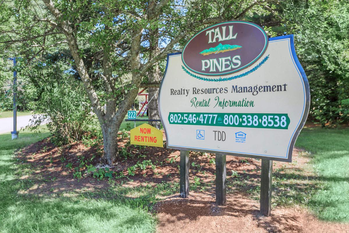 a sign in front of a tree