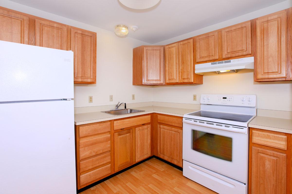 a kitchen with stainless steel appliances and wooden cabinets