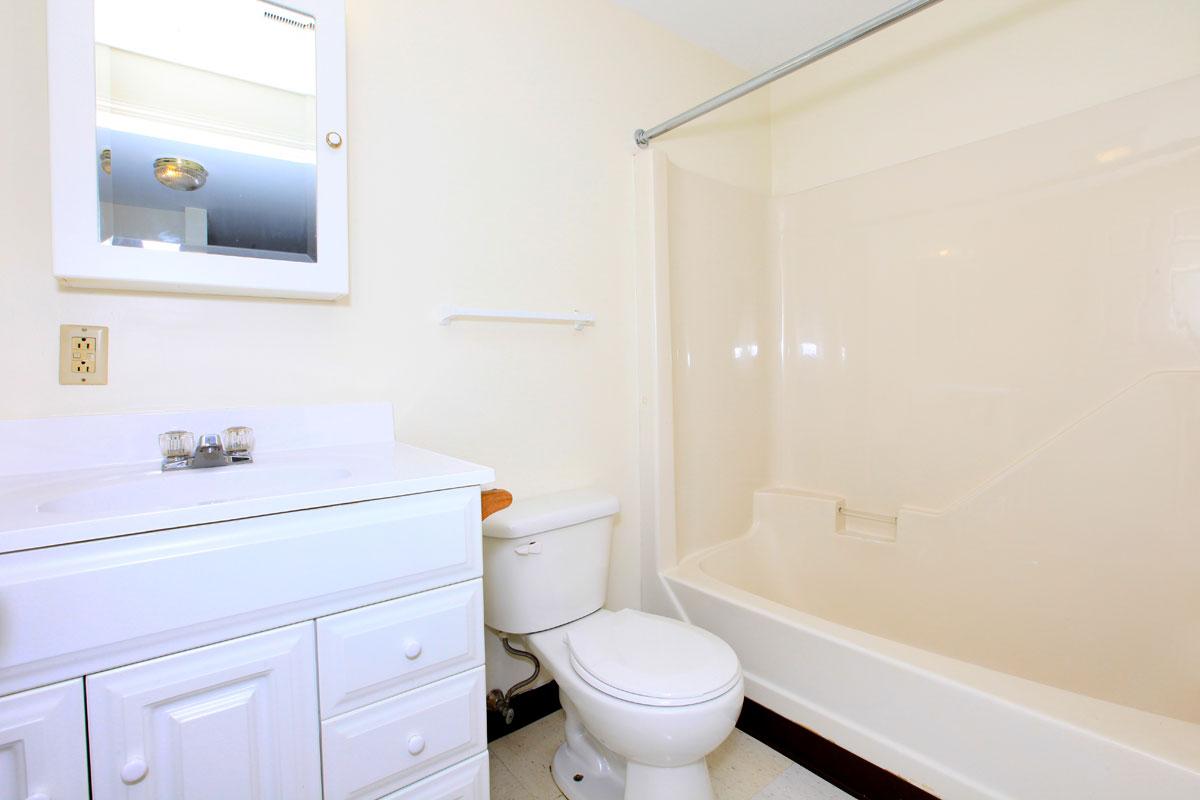 a white tub sitting next to a sink