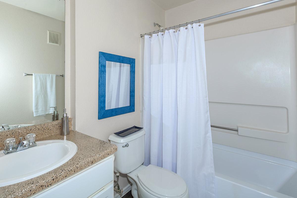 a white tub sitting next to a sink
