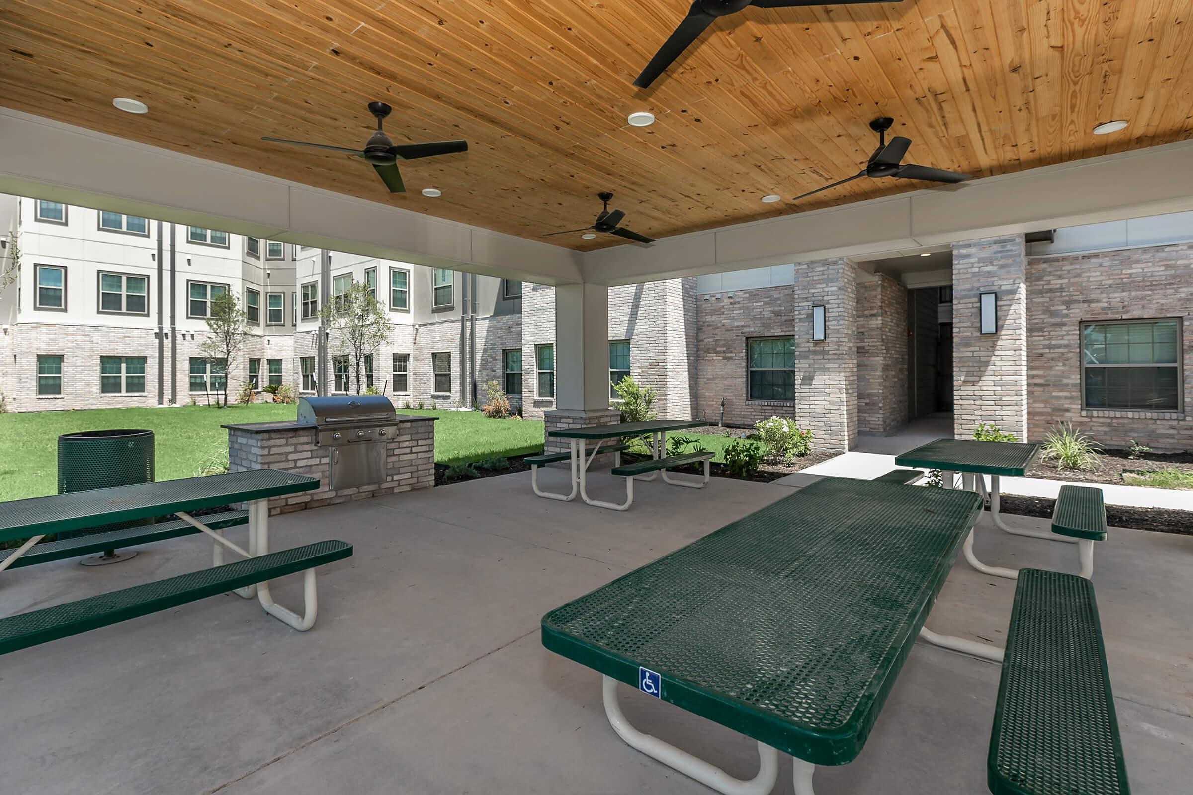 a green bench in front of a building