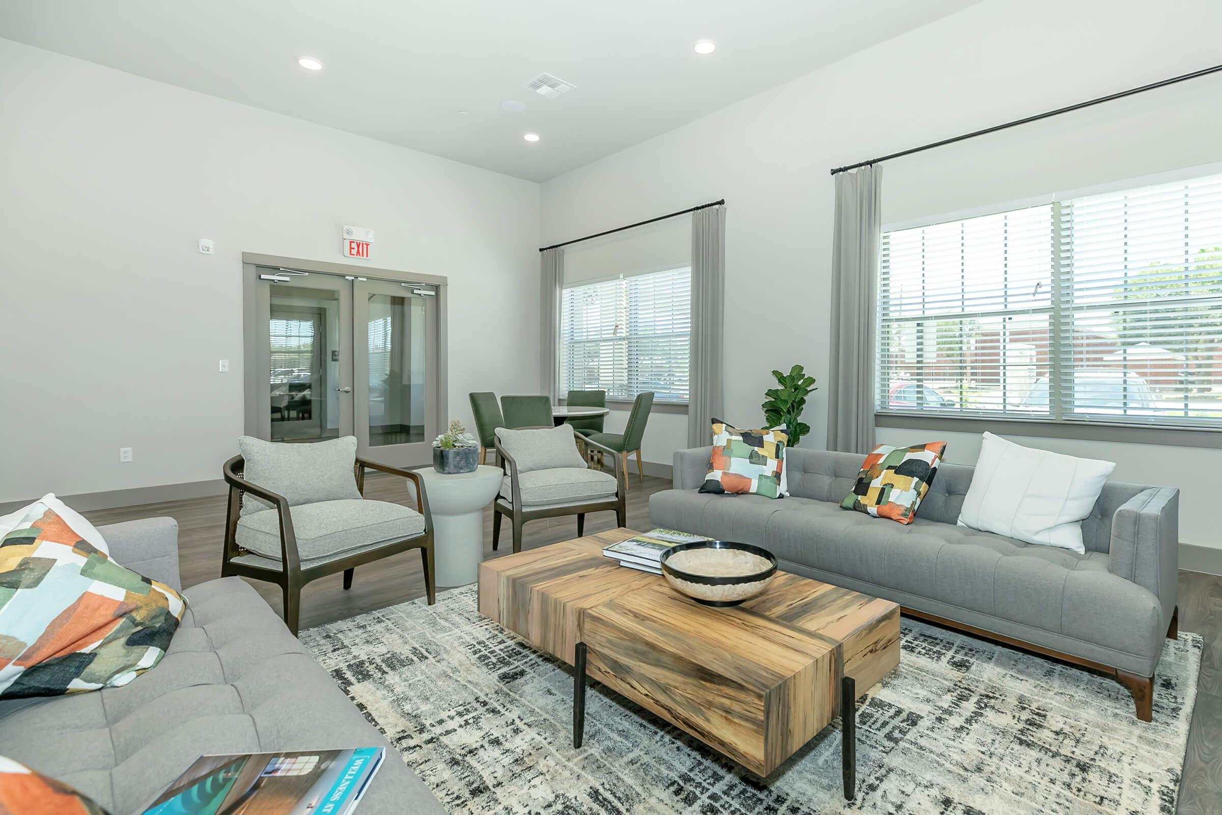 a living room filled with furniture and a large window