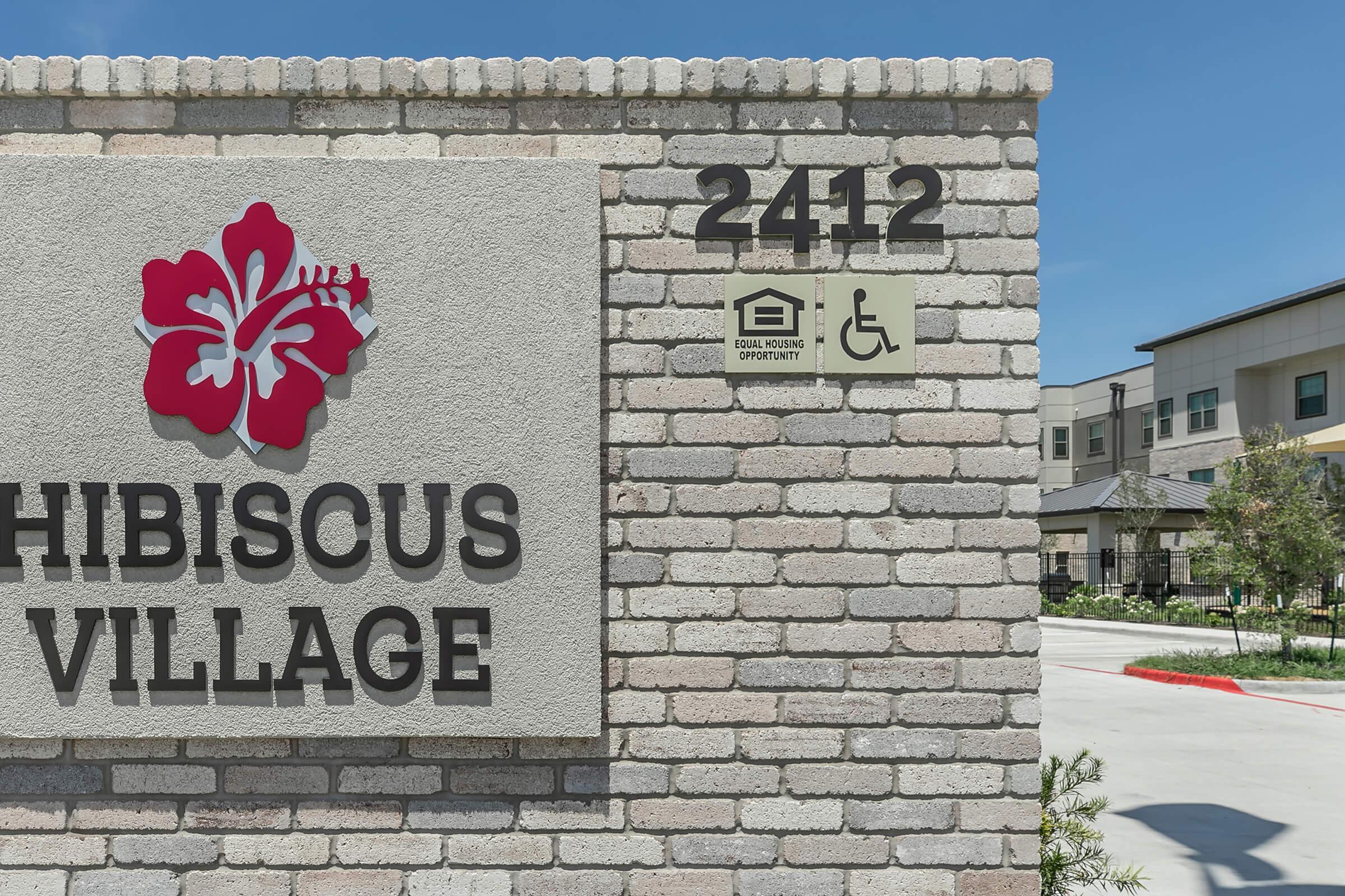 a sign in front of a brick building