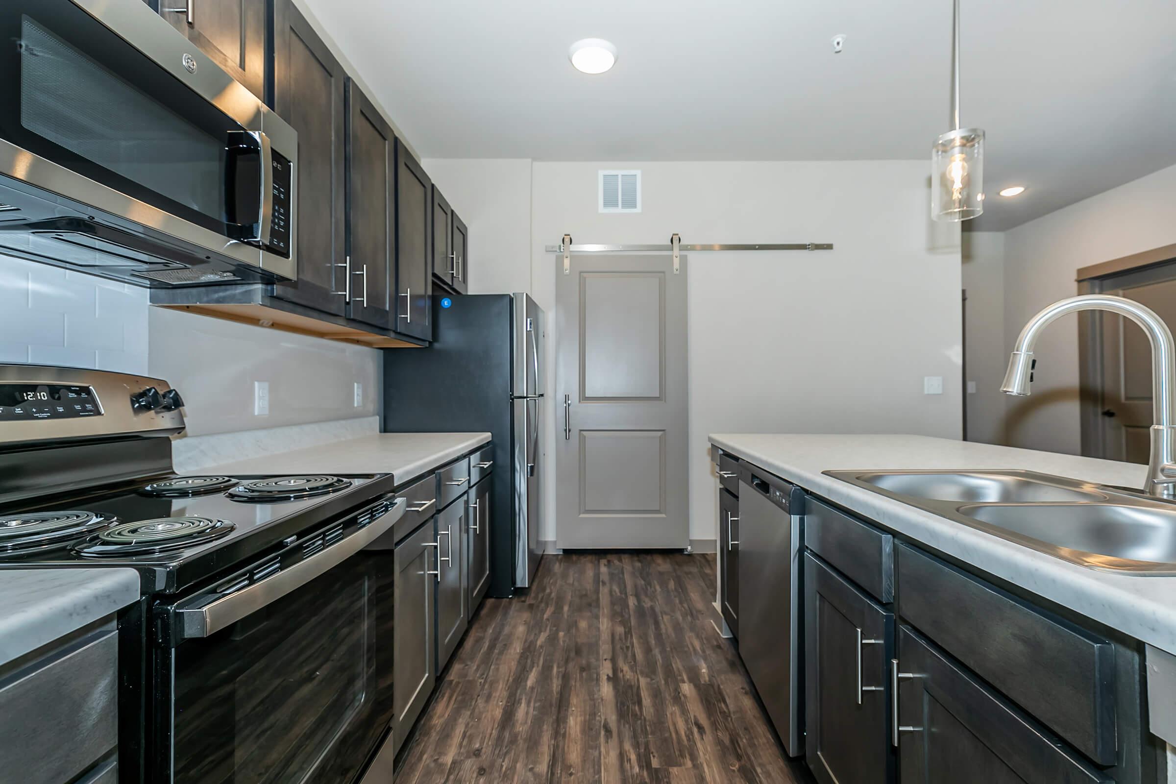 a large kitchen with stainless steel appliances