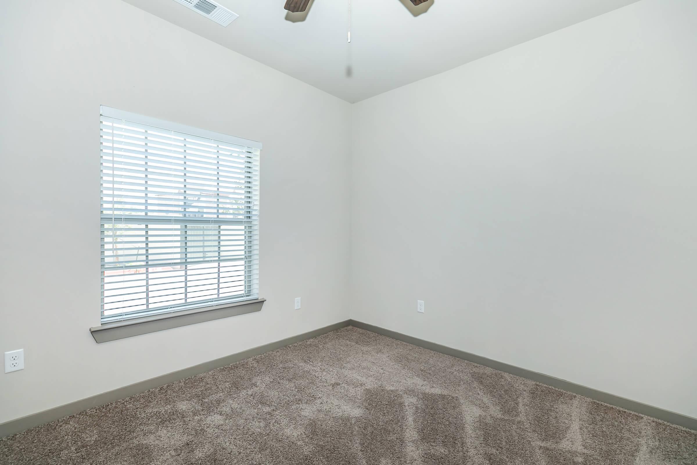 a bedroom with a large window