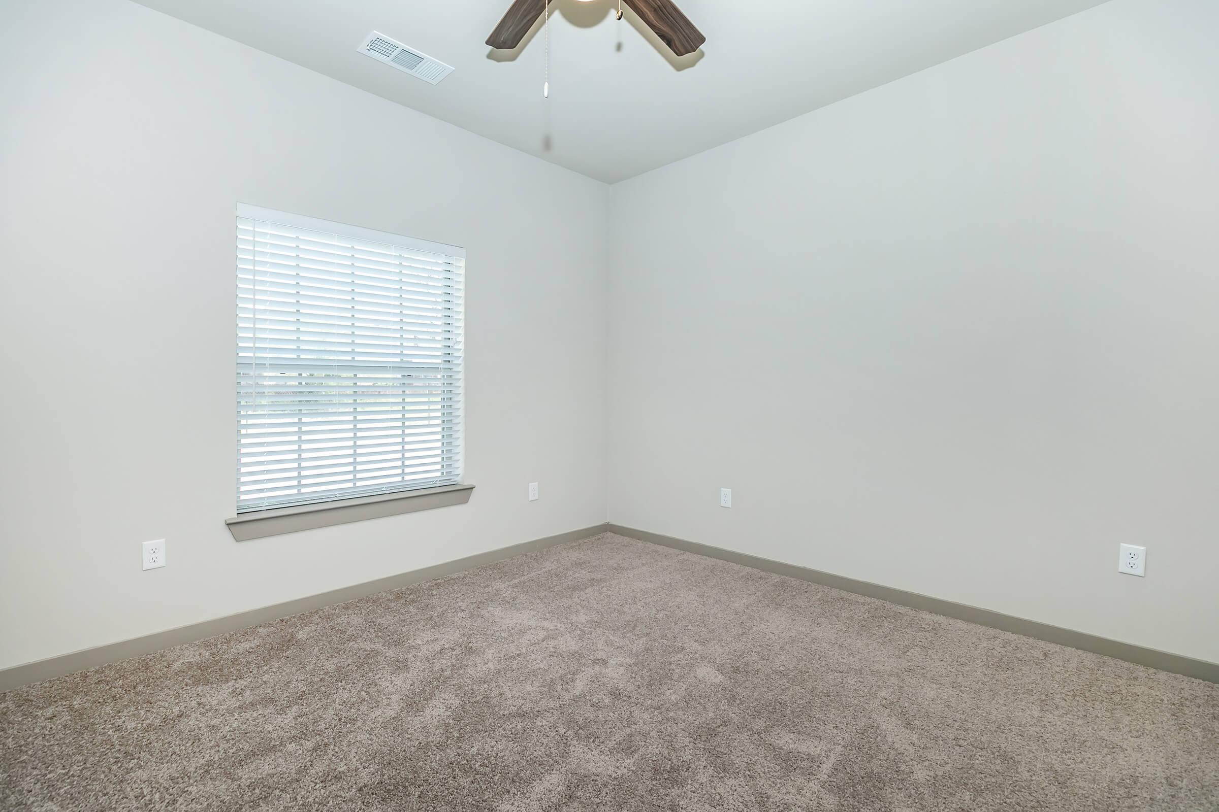 a bedroom with a large window