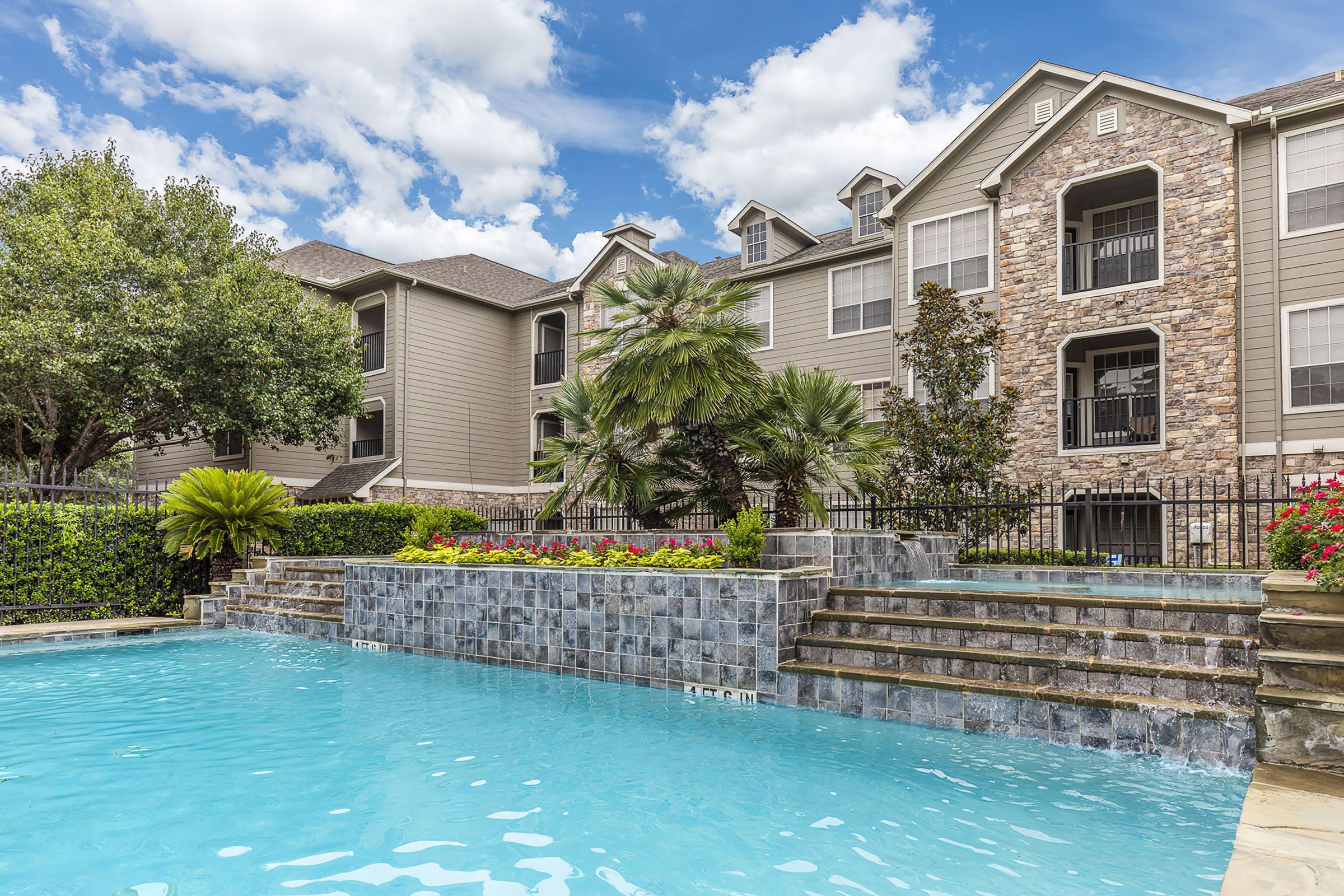 a large pool of water in front of a house