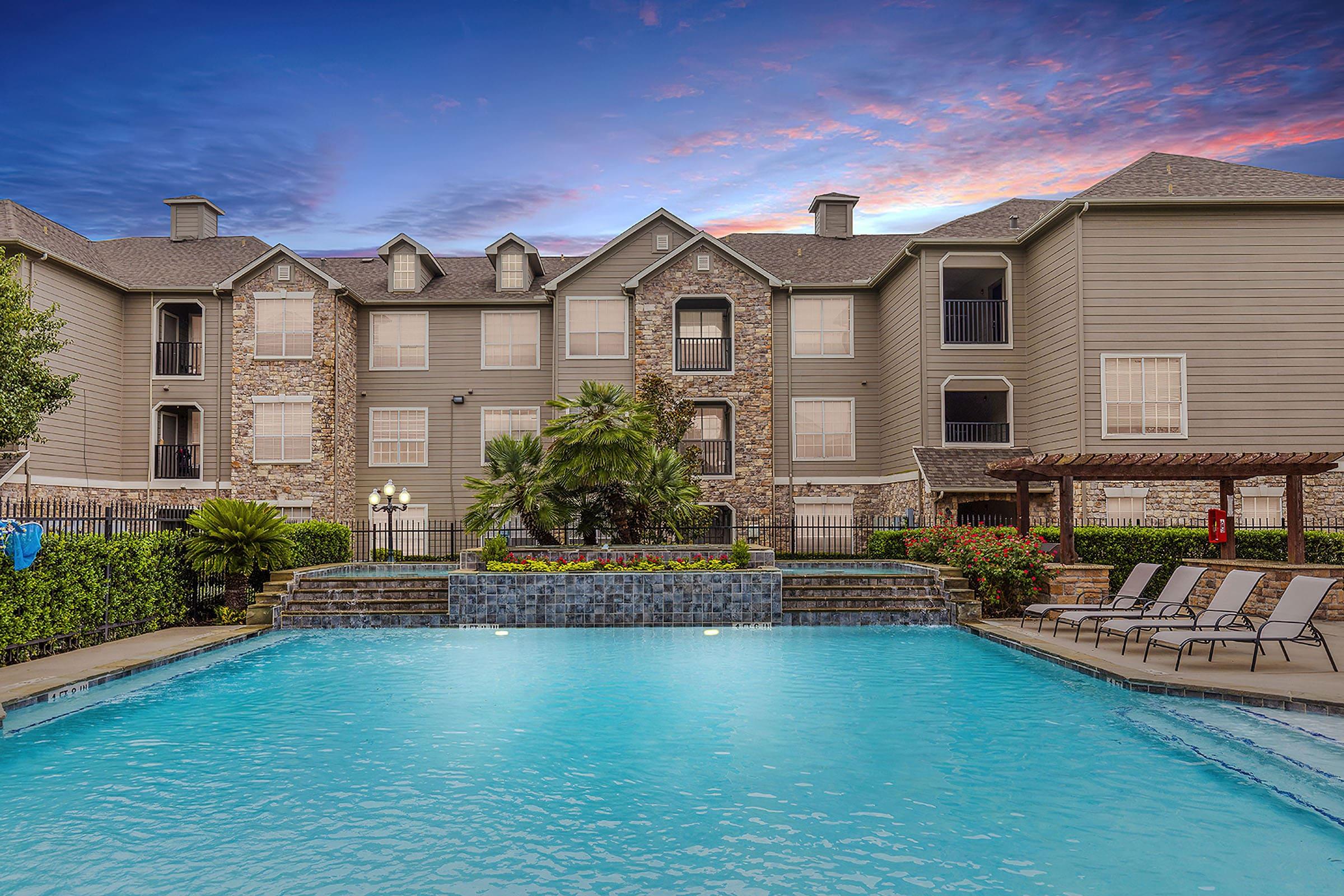 a large pool of water in front of a house