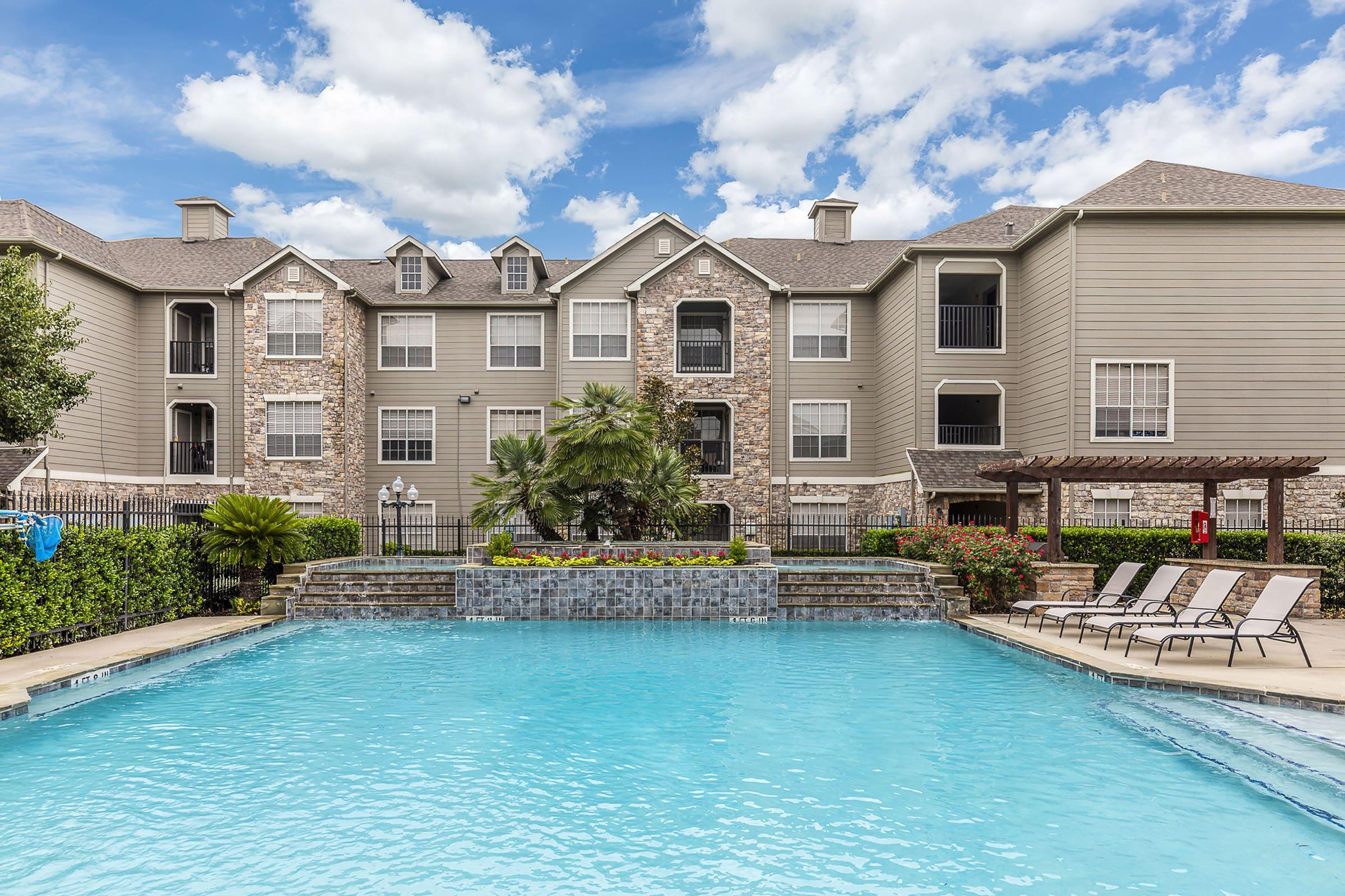 a large pool of water in front of a house