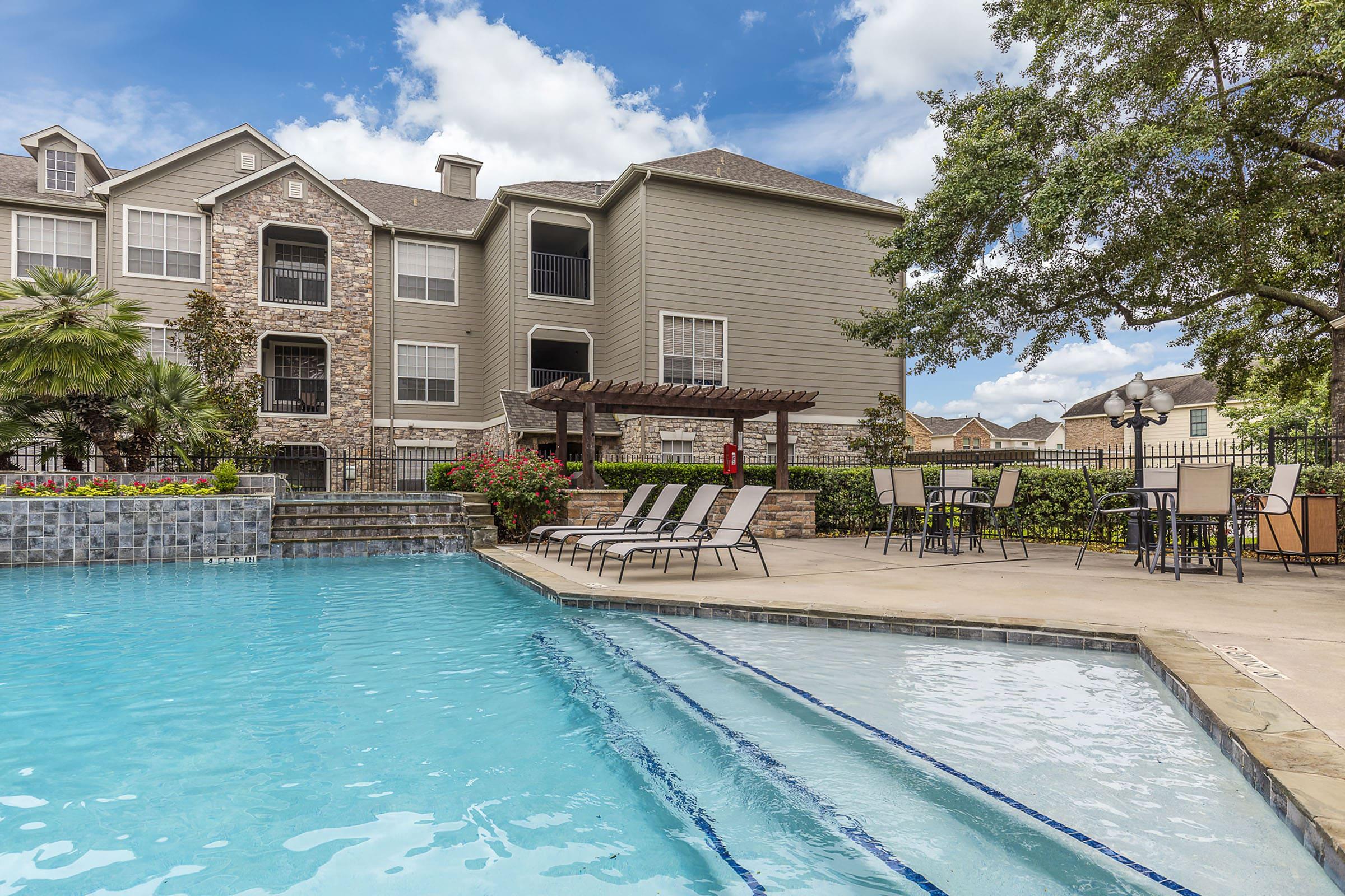 a large pool of water in front of a house