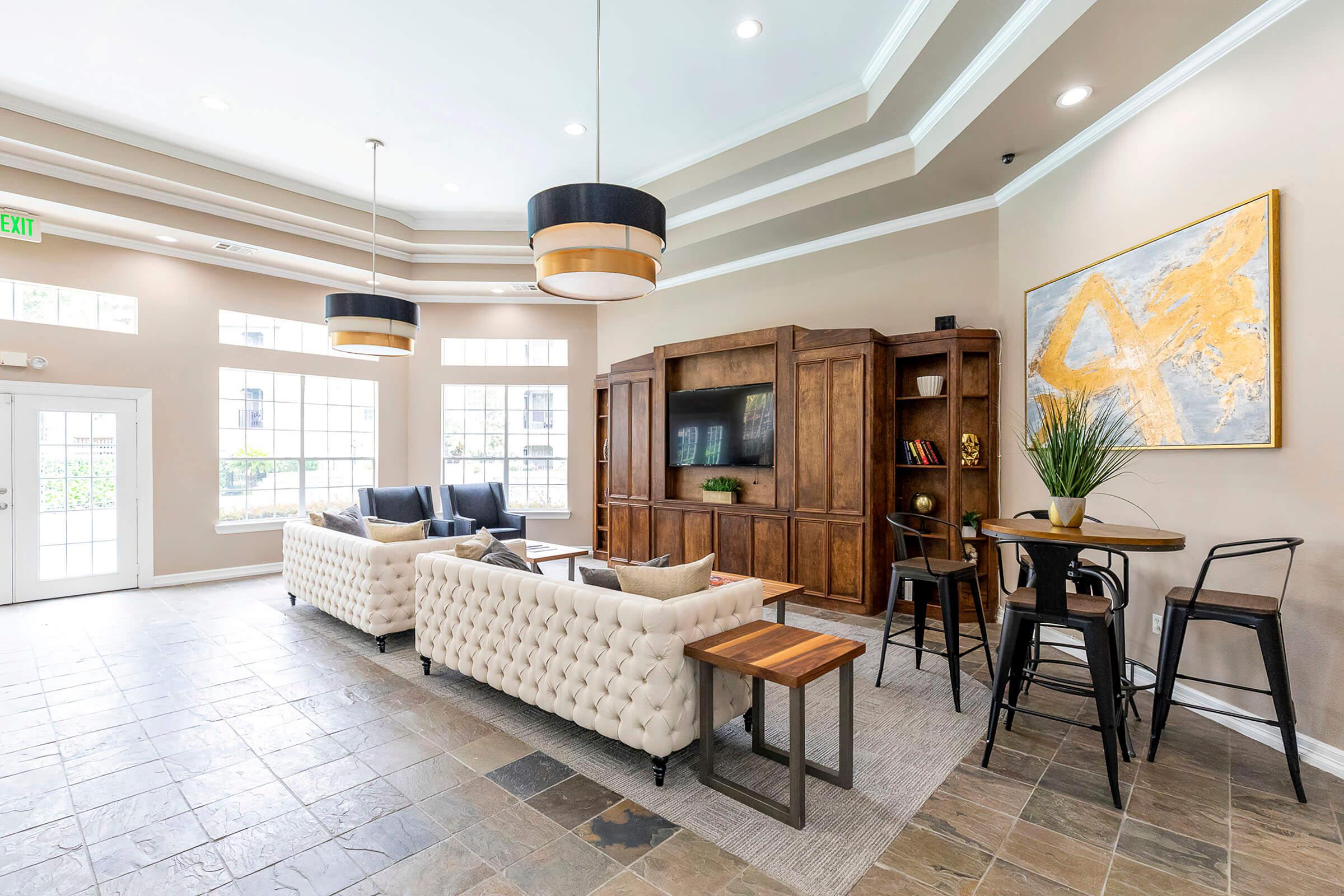 a living room filled with furniture and a large window