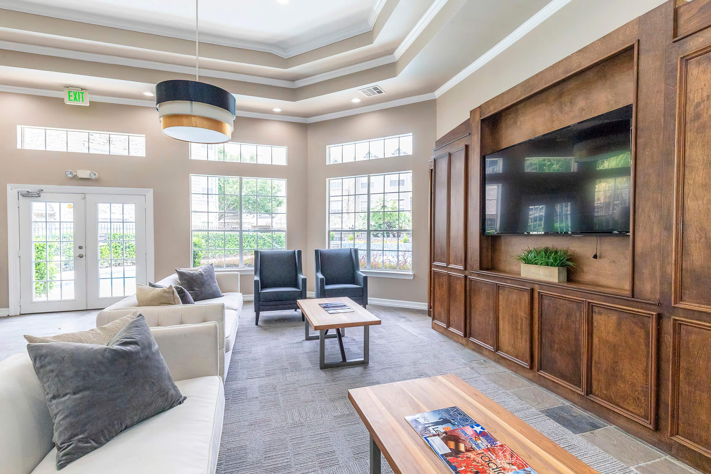 a living room filled with furniture and a large window