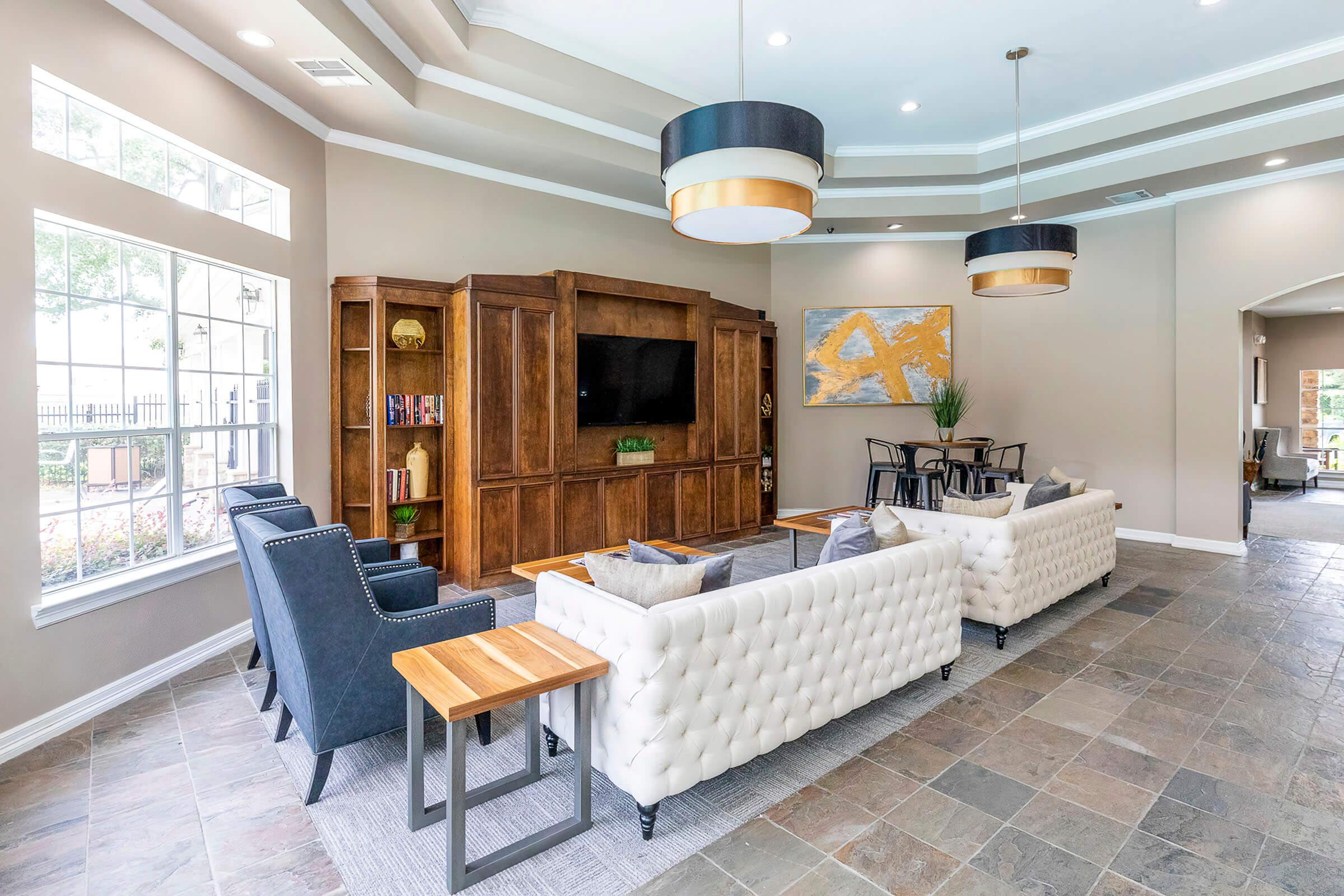 a living room filled with furniture and a large window