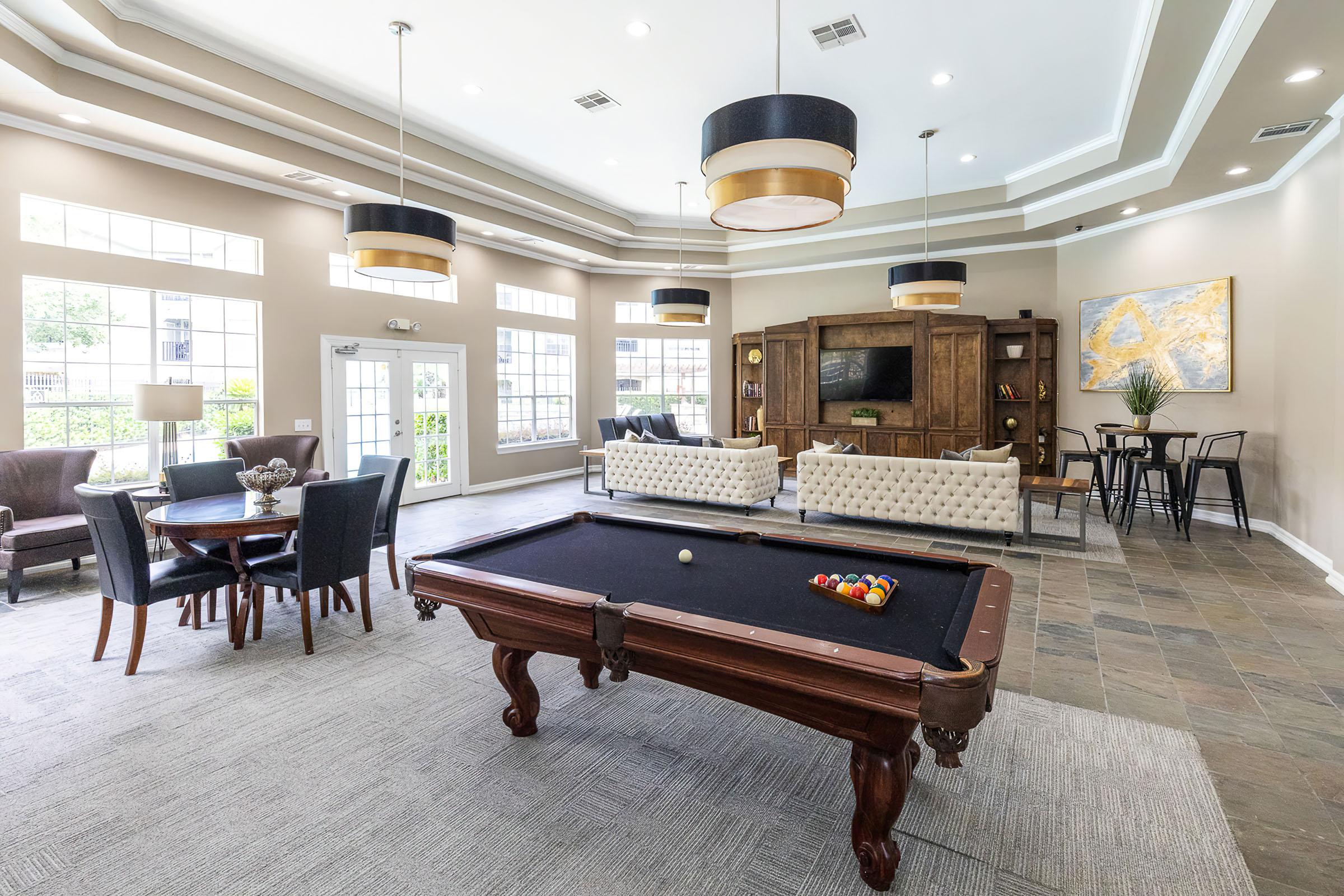 a living room filled with furniture and a large window