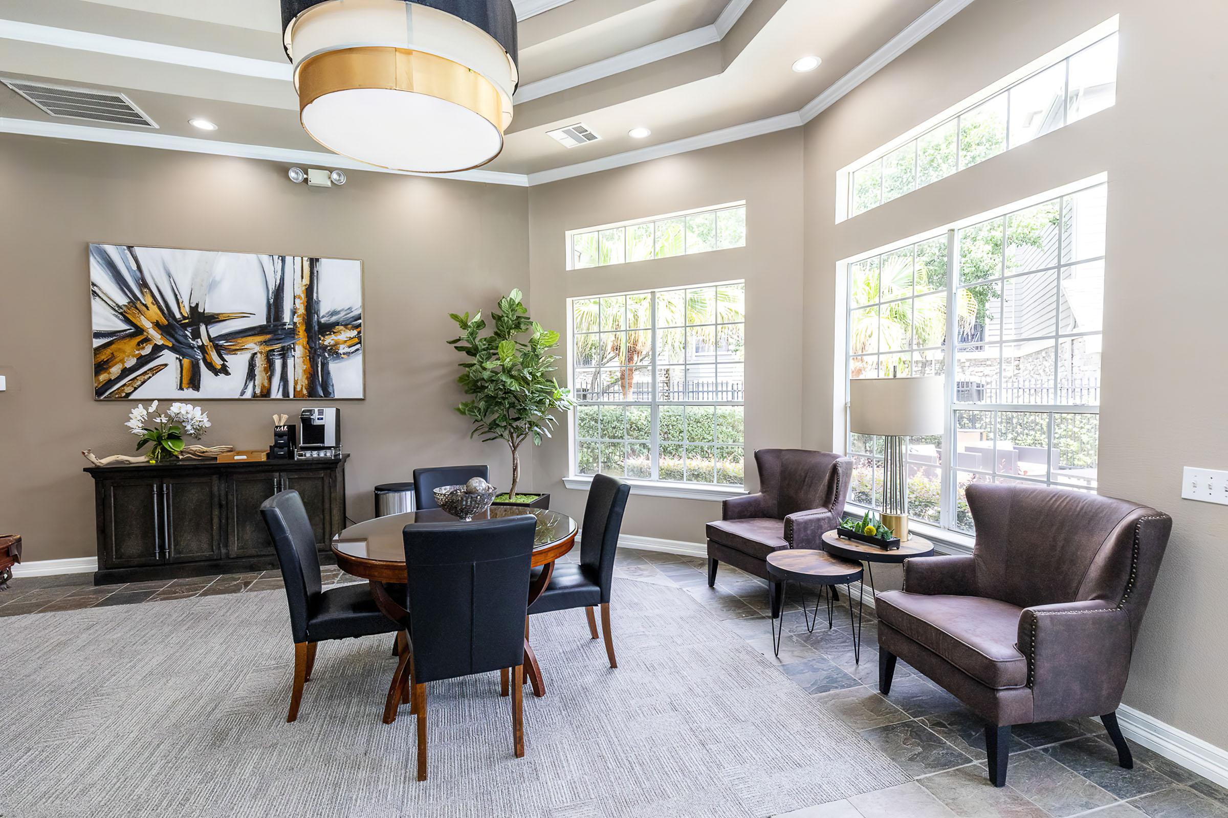 a living room filled with furniture and a large window