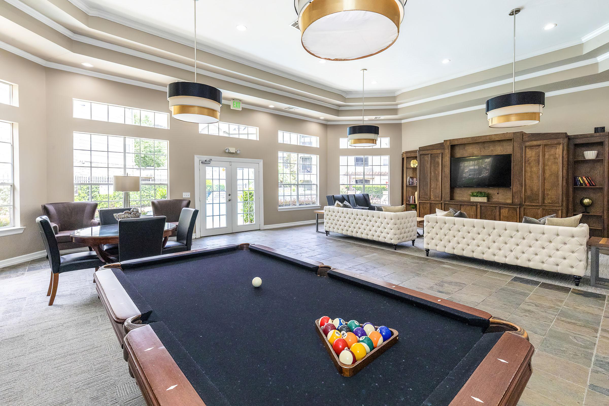 a living room filled with furniture and a large window