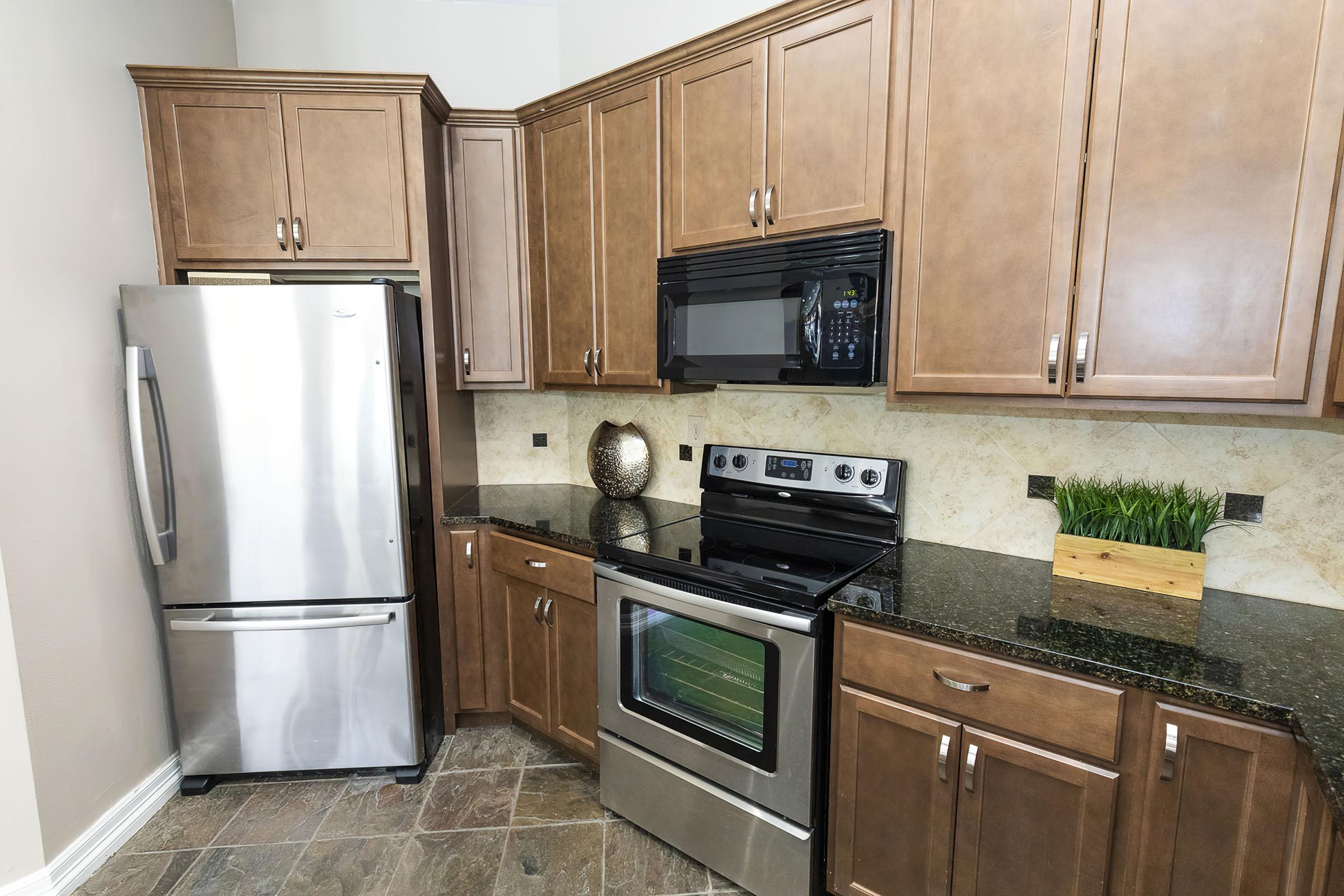 a kitchen with stainless steel appliances and wooden cabinets