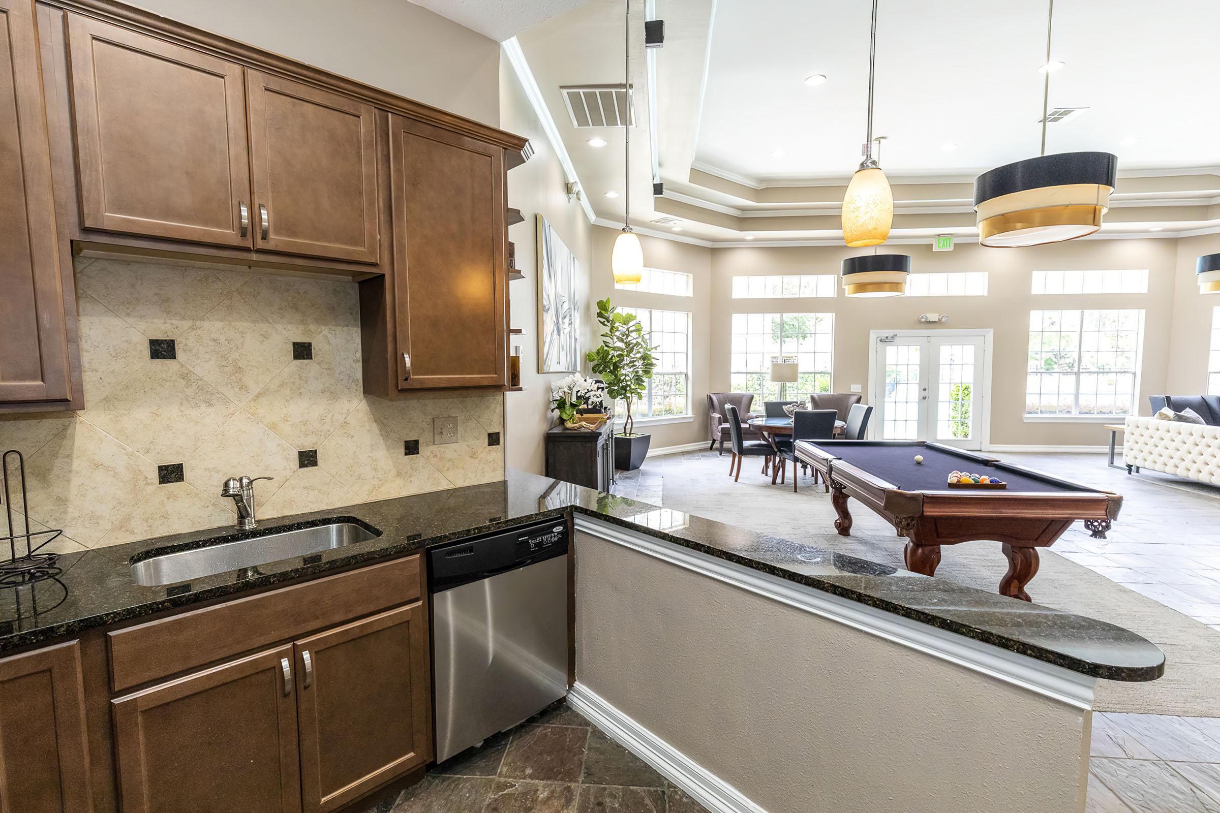 a kitchen with a sink and a mirror