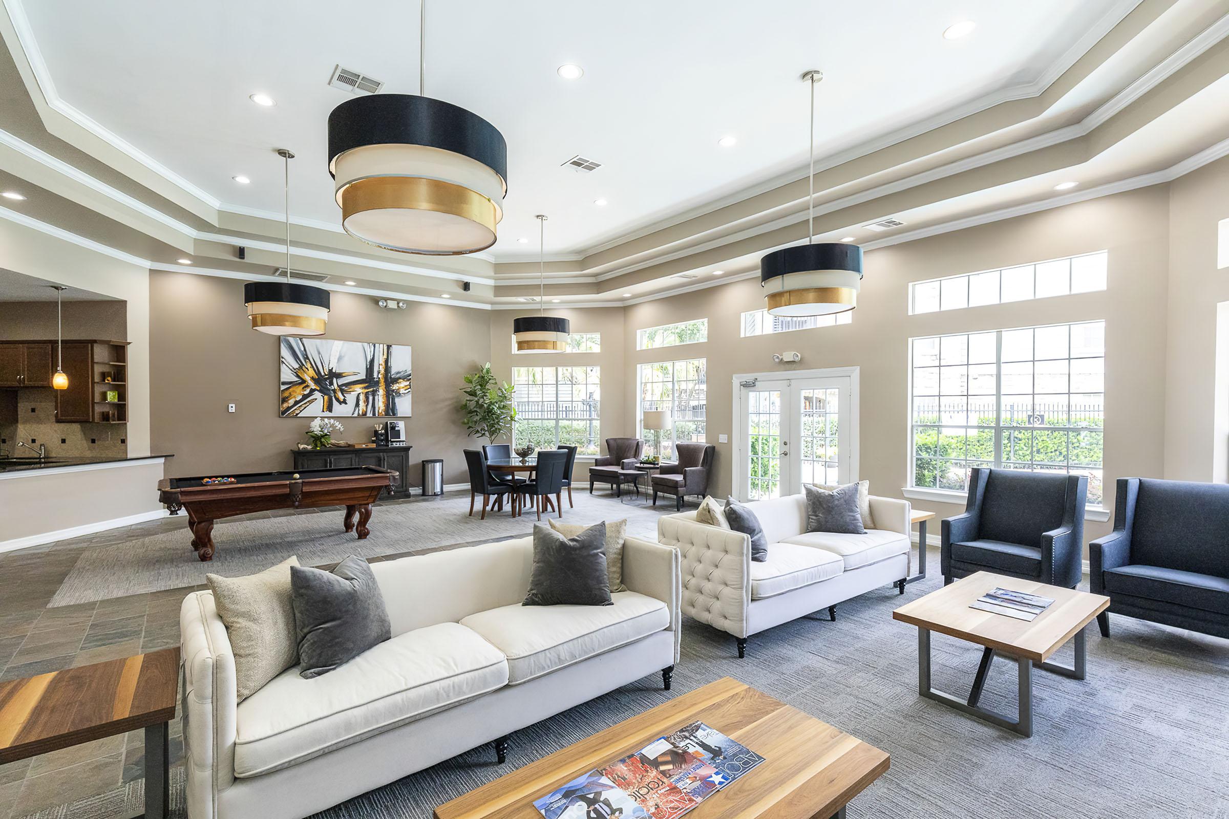 a living room filled with furniture and a large window