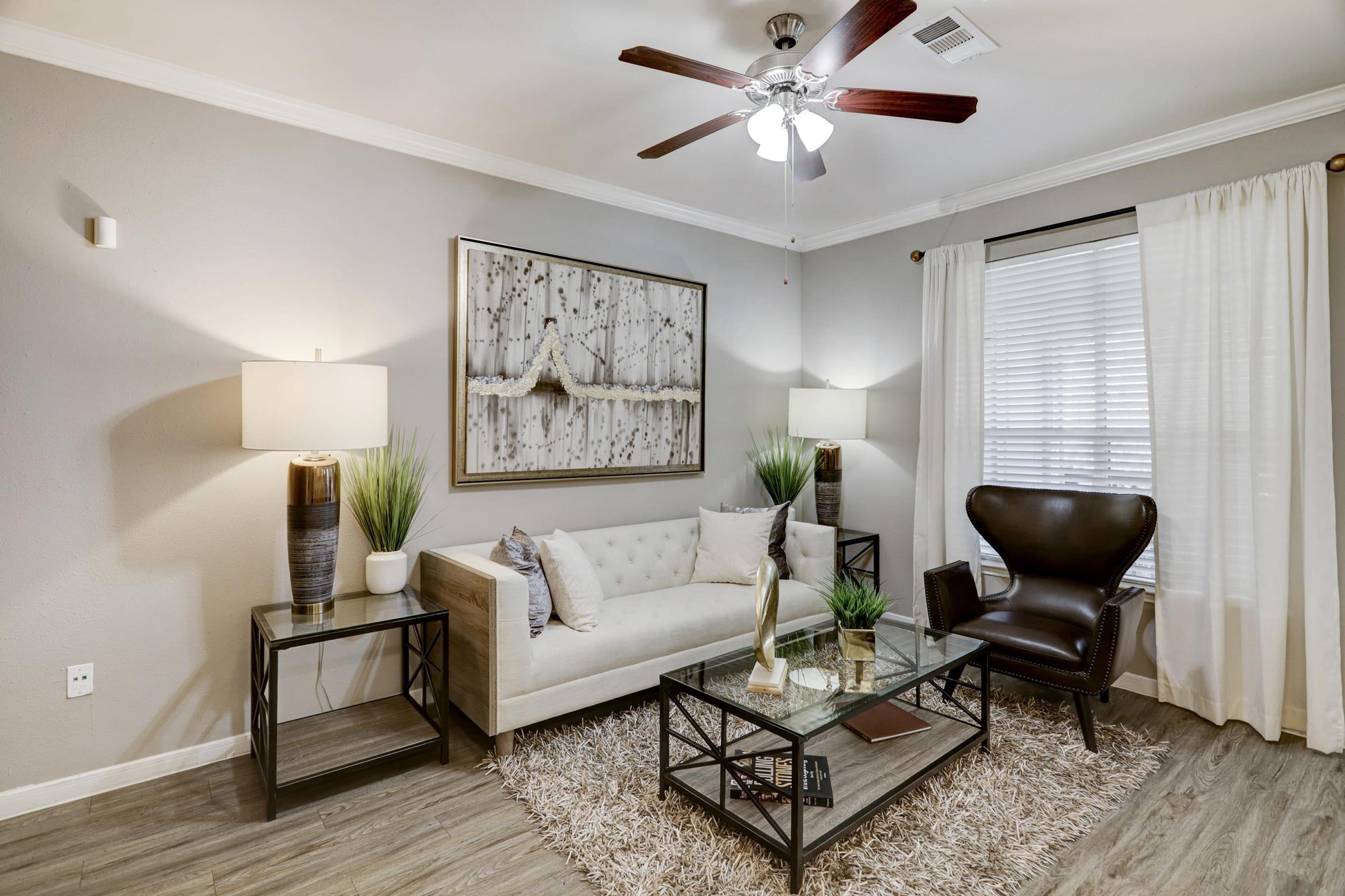 a living room filled with furniture and a large window