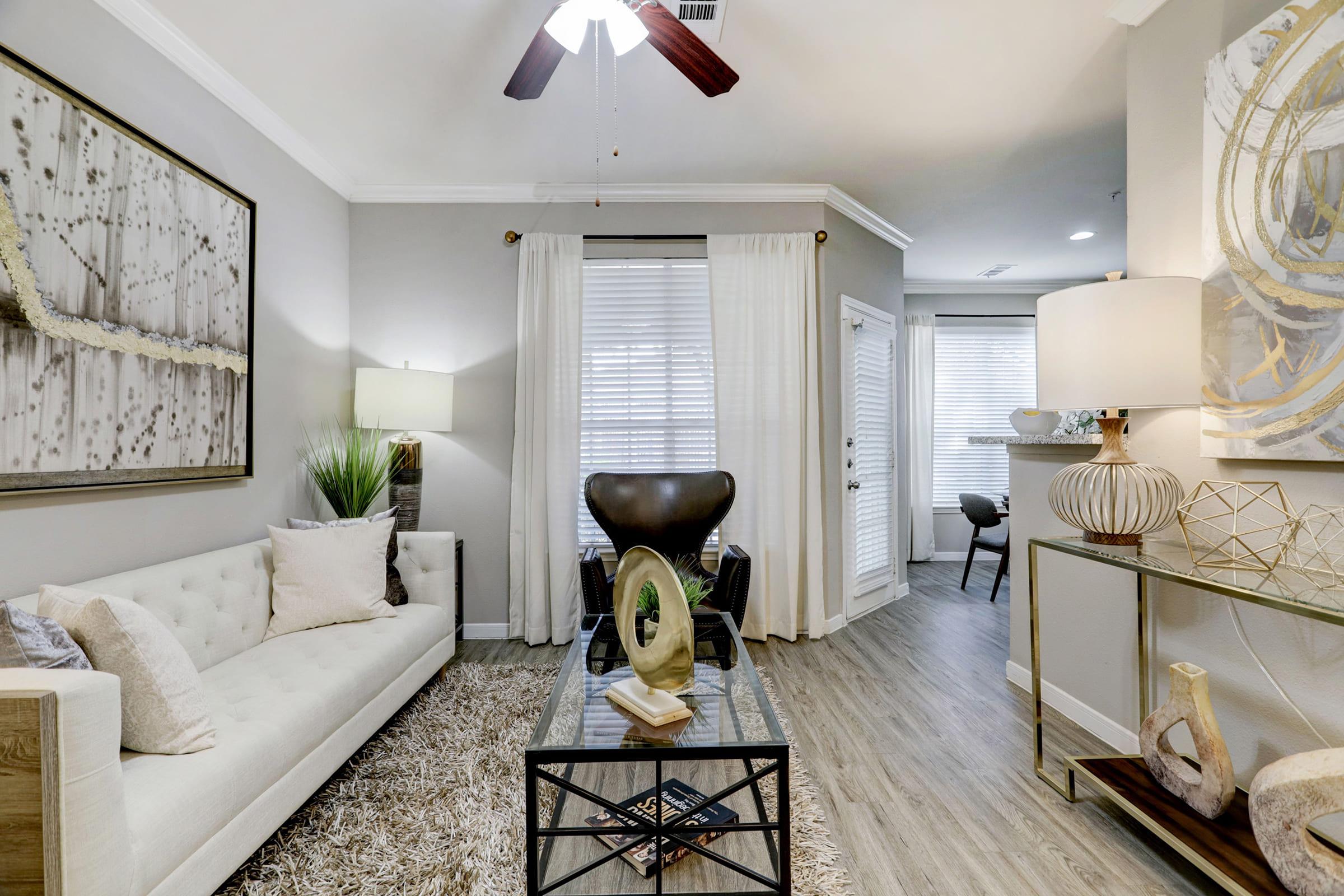 a living room filled with furniture and a large window