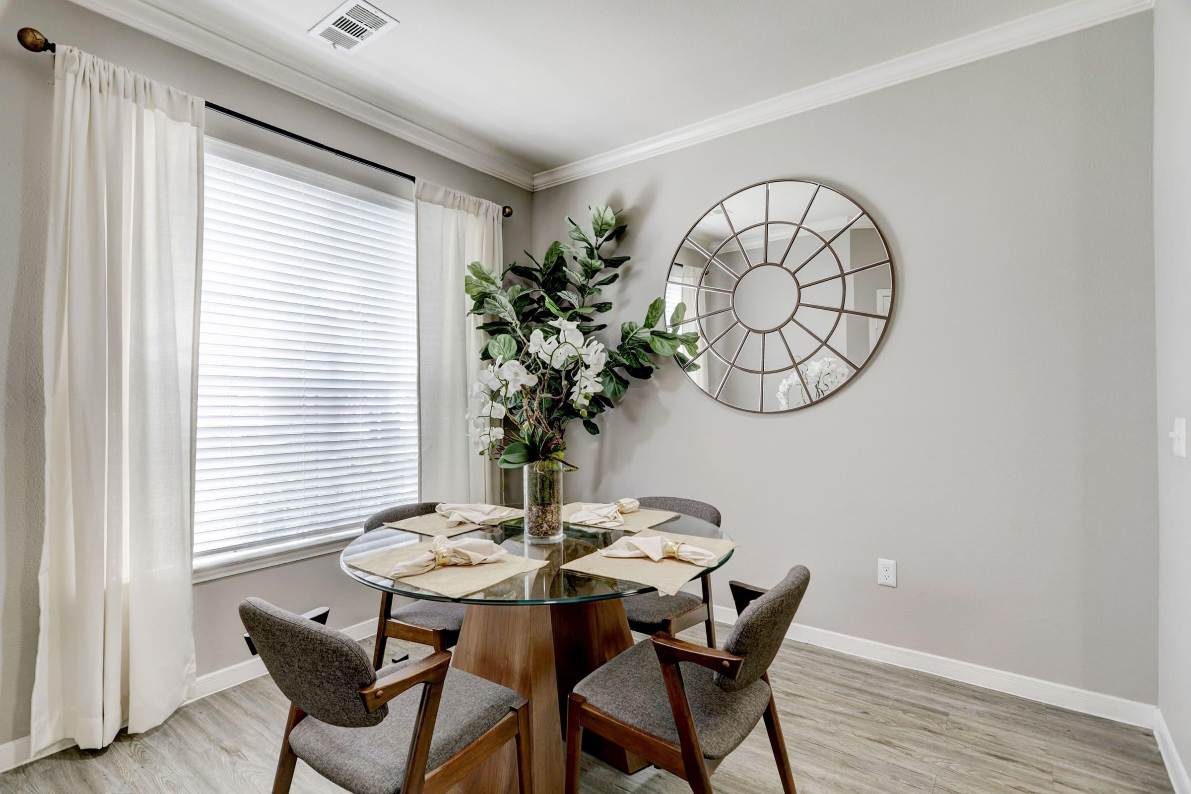 a room filled with furniture and vase of flowers on a table