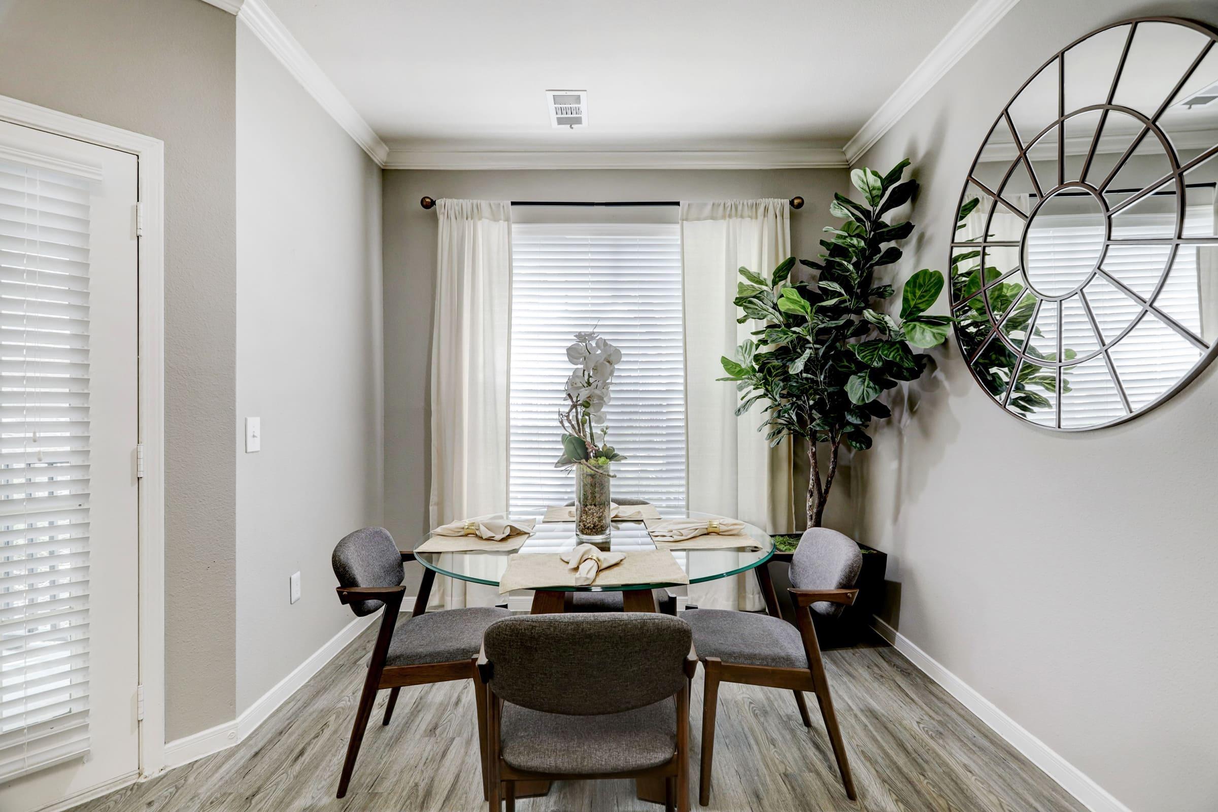 a living room filled with furniture and vase of flowers on a table