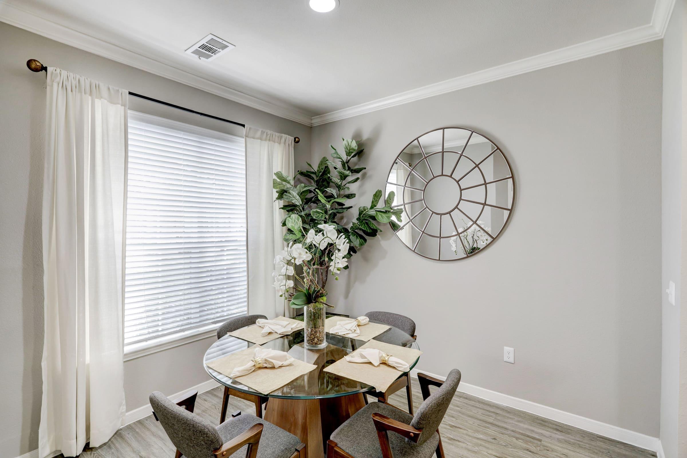 a room filled with furniture and vase of flowers on a table