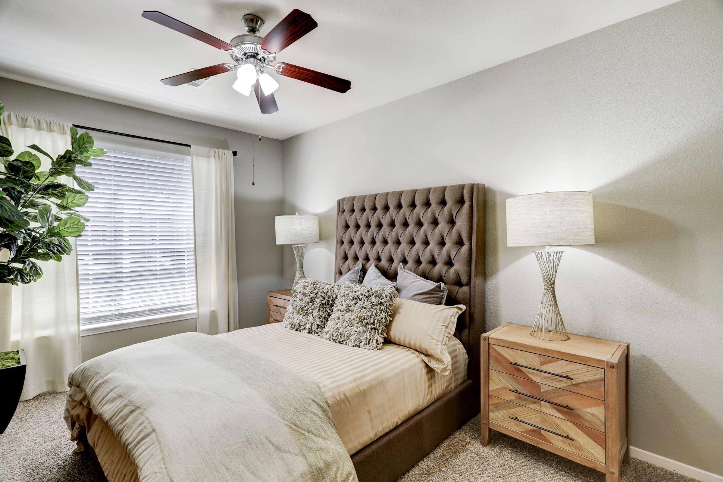 a living room with a bed and chair