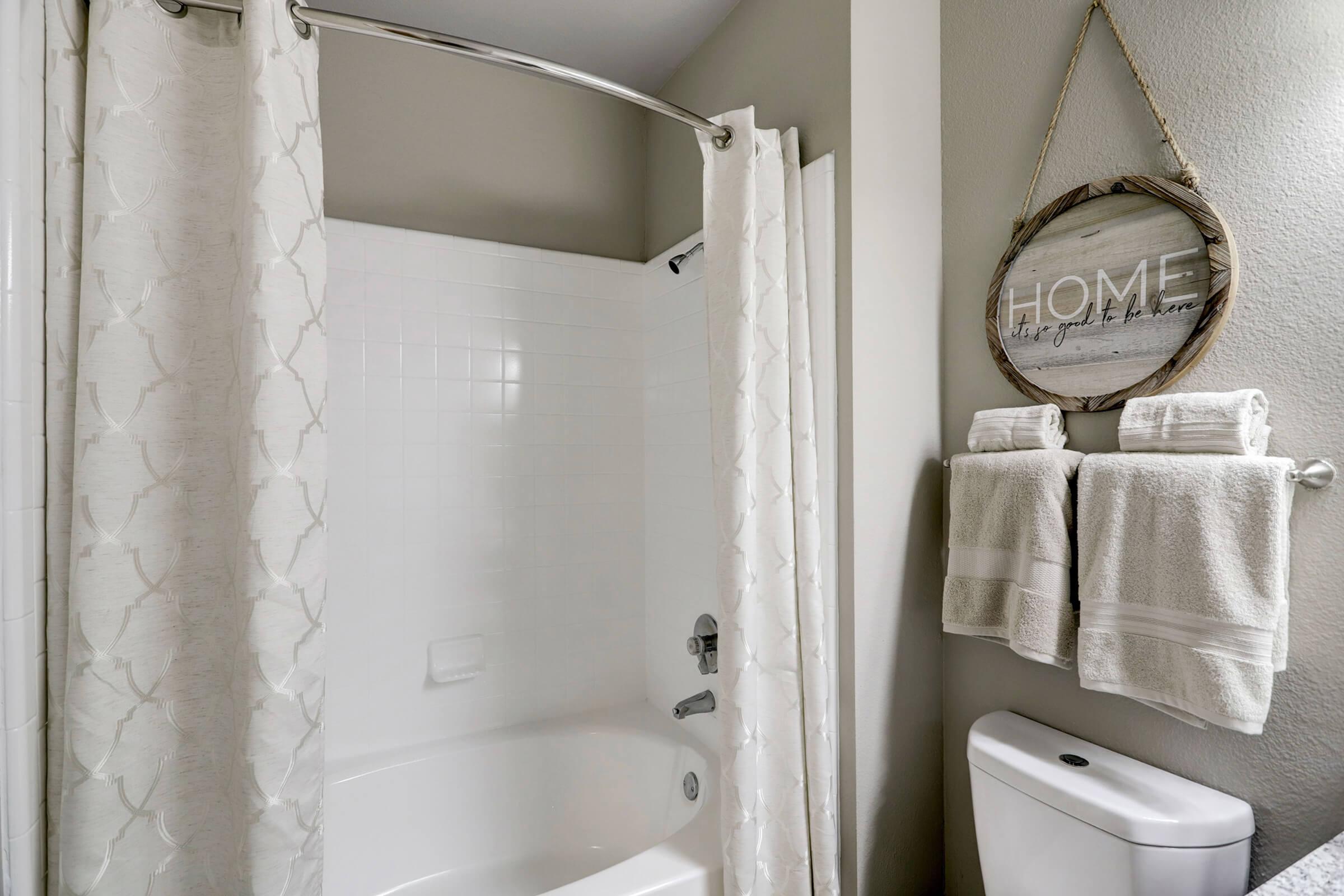 a shower curtain next to a sink