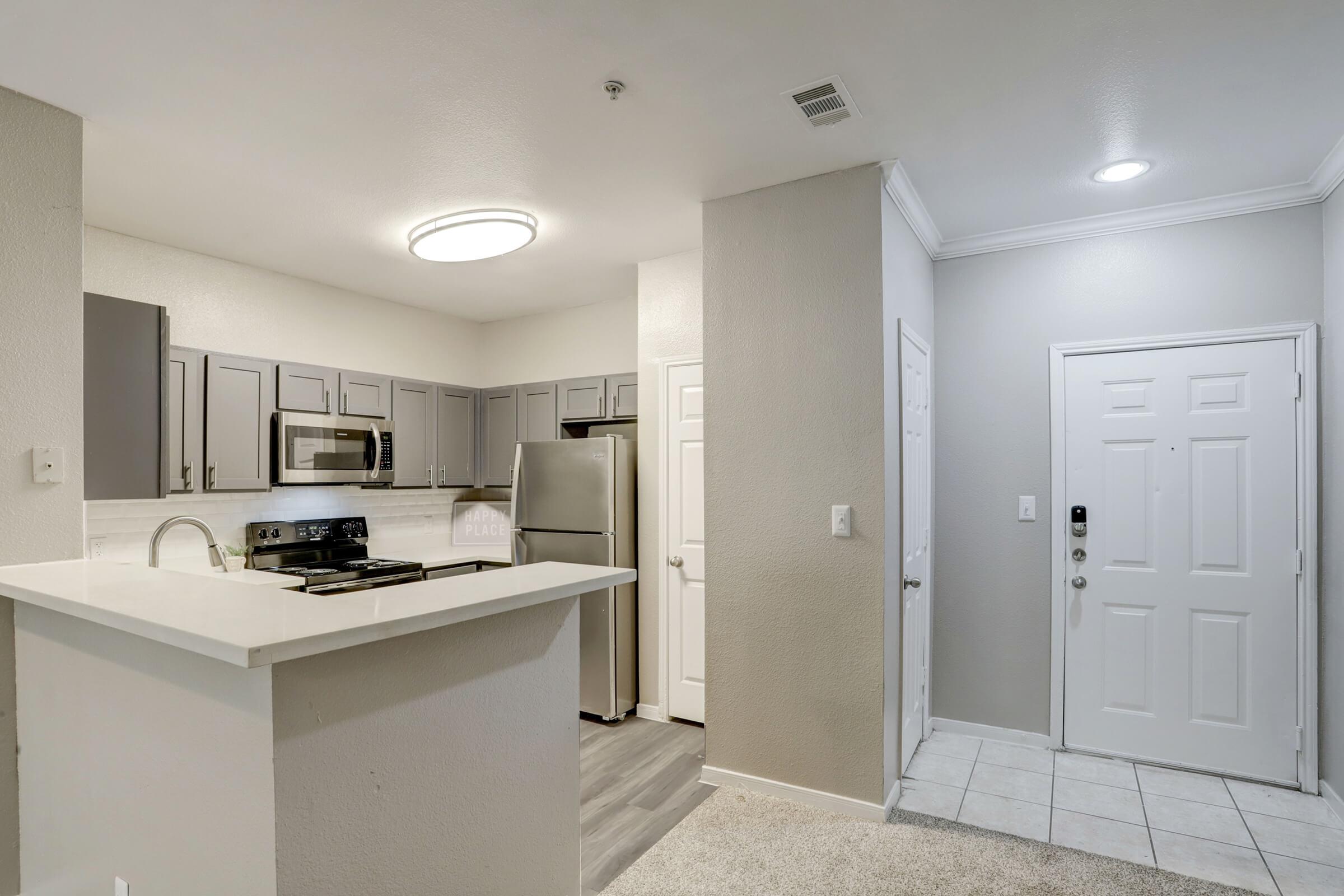 a kitchen with a sink and a mirror