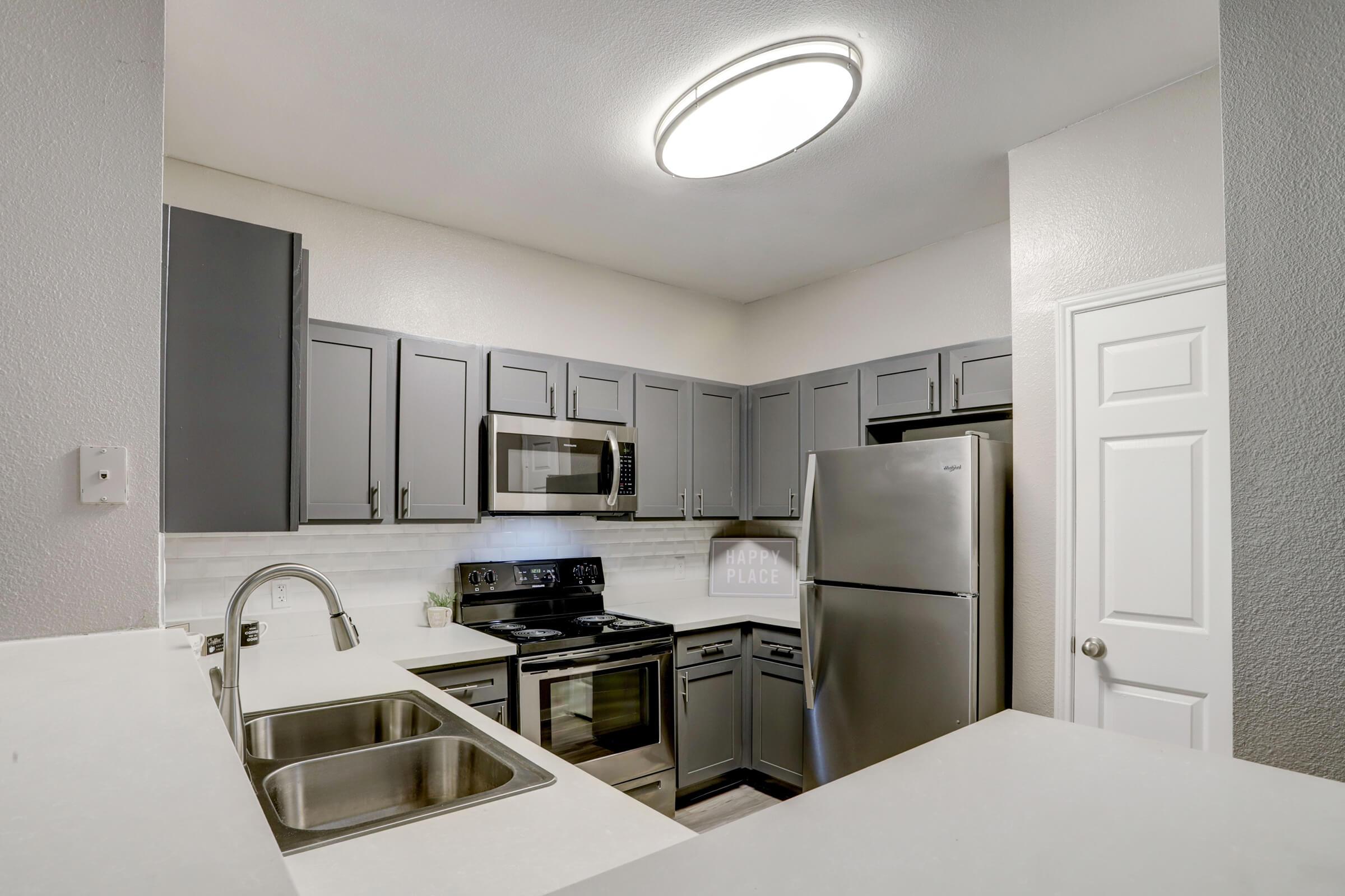 a kitchen with a sink and a refrigerator