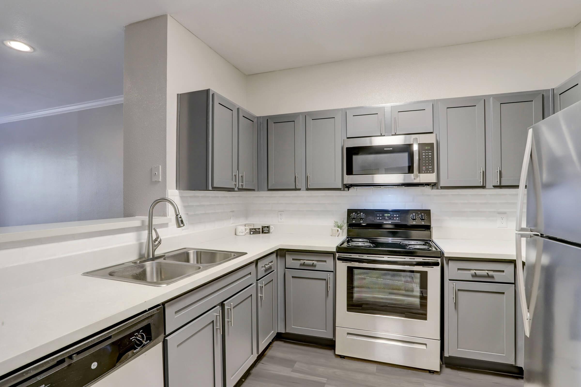 a stove top oven sitting inside of a kitchen