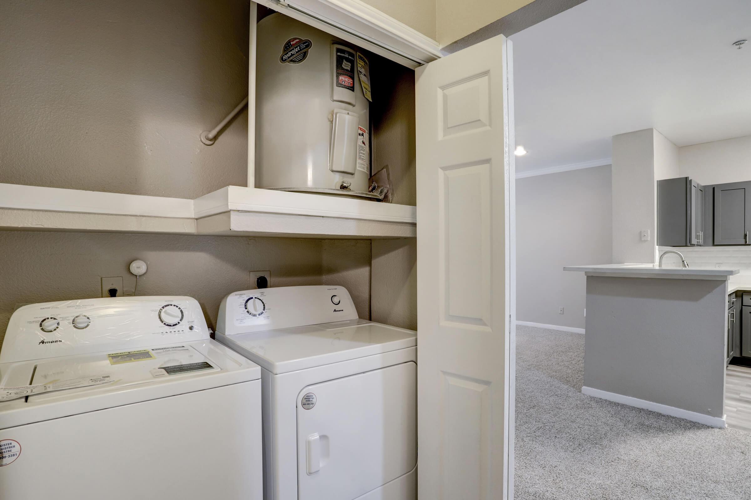 a room with a sink and a refrigerator