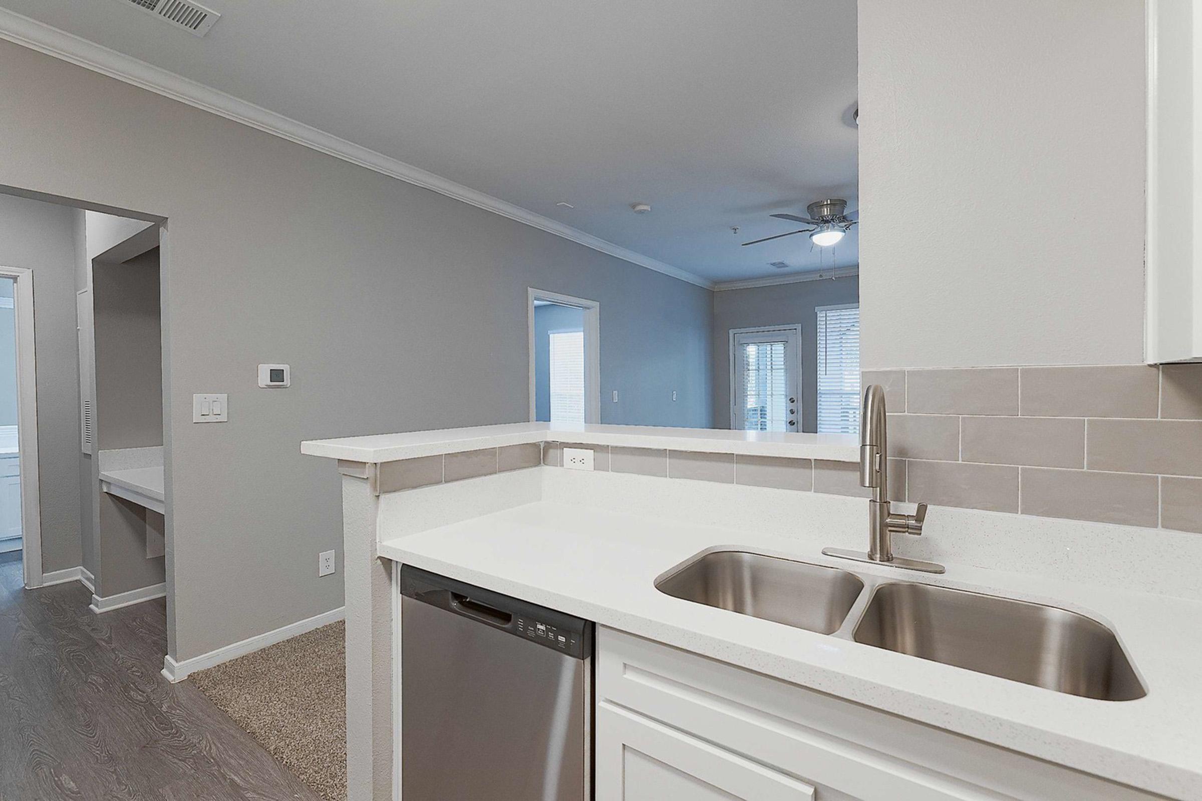 a kitchen with a sink and a mirror