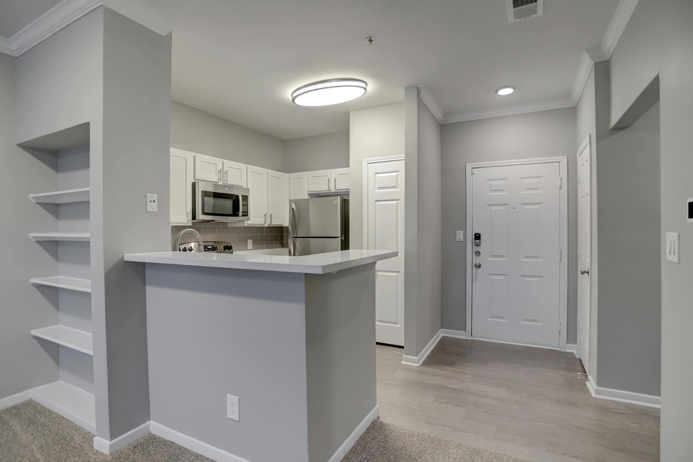 a large empty room with a sink and a mirror