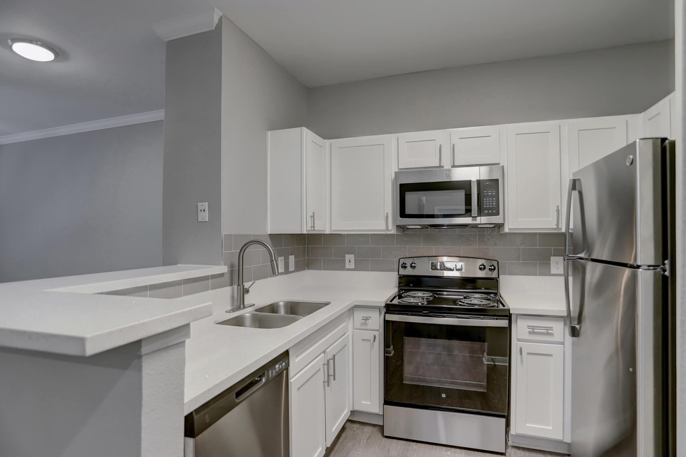 a stove top oven sitting inside of a kitchen