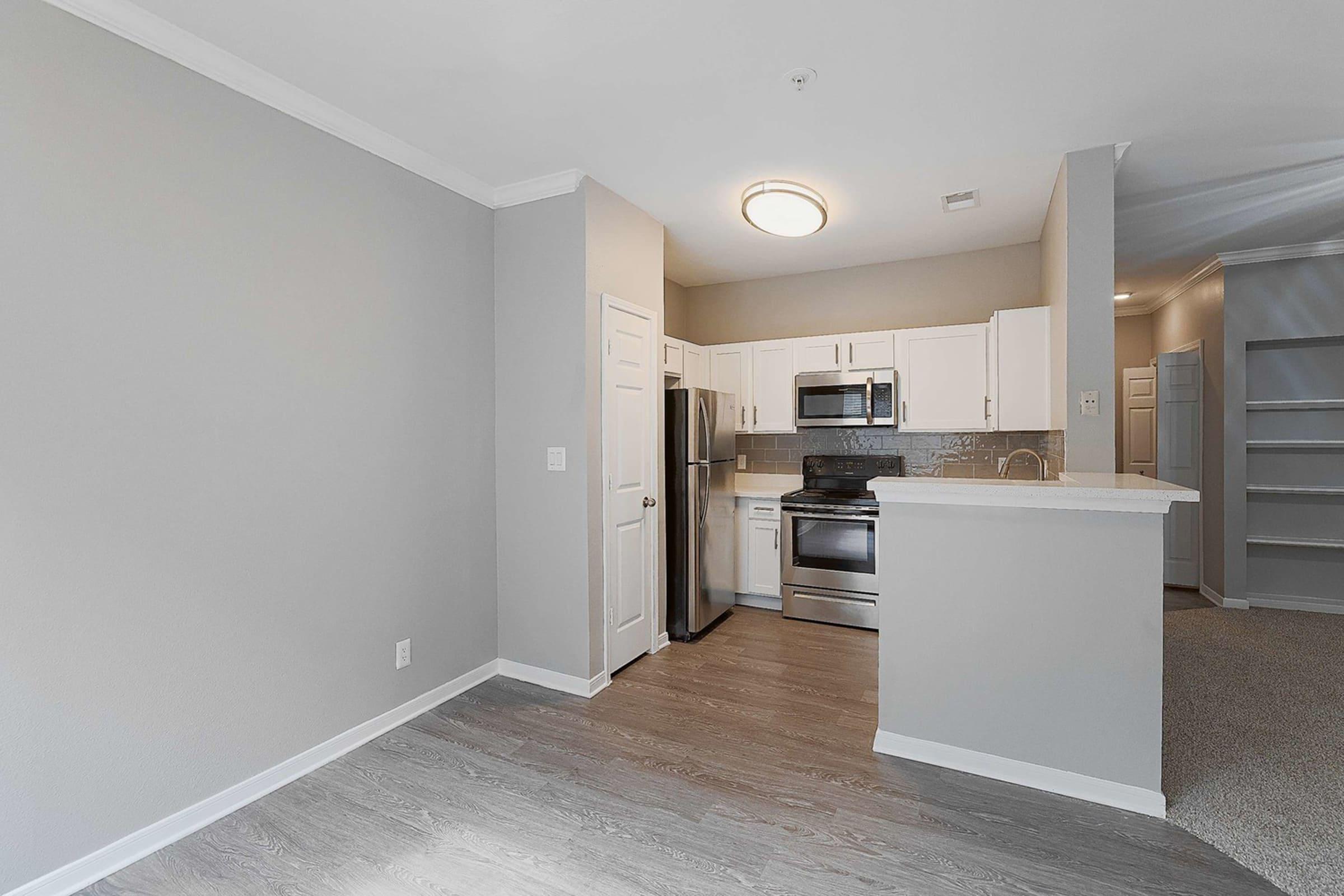 a kitchen with a refrigerator in a room