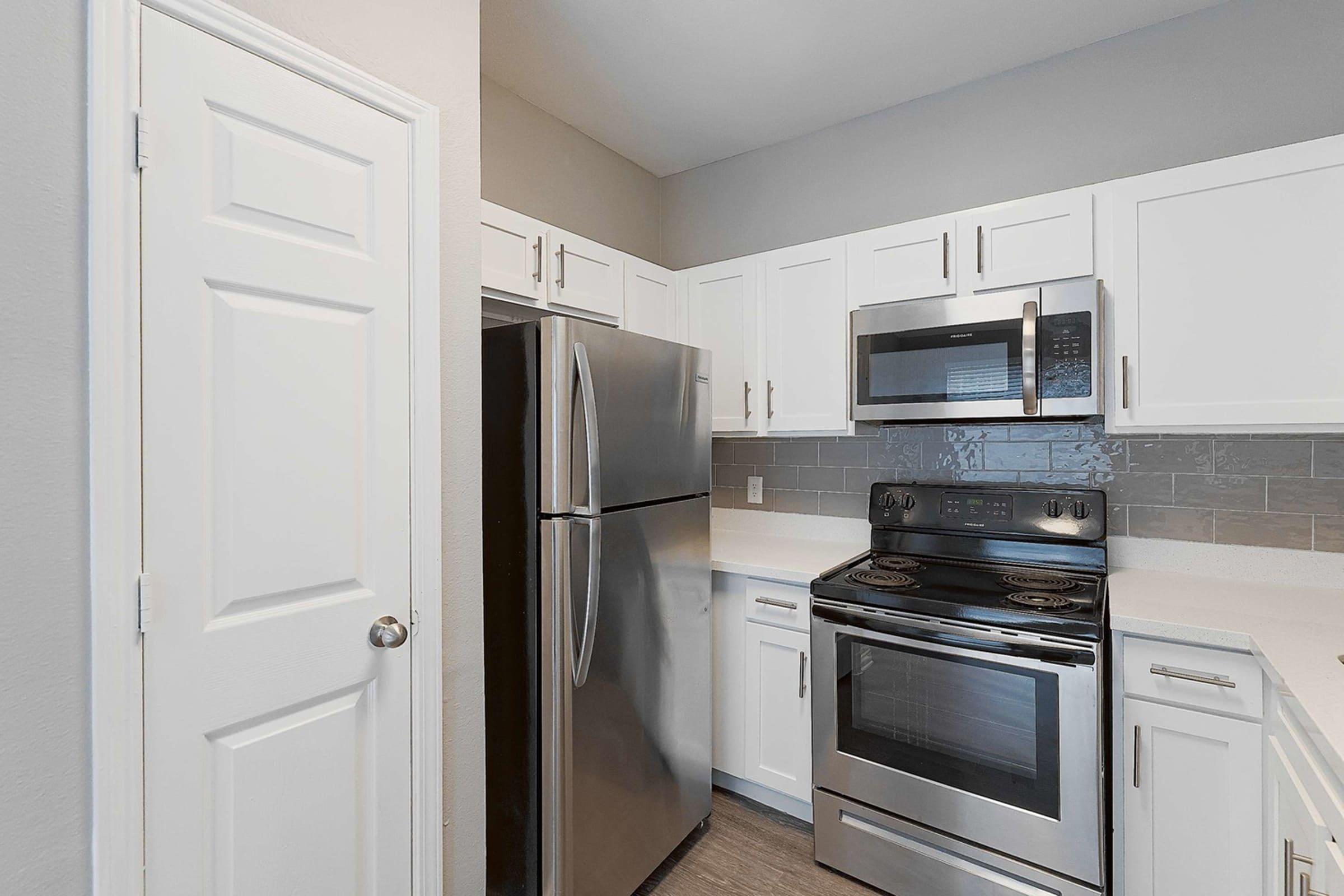 a stove top oven sitting inside of a kitchen