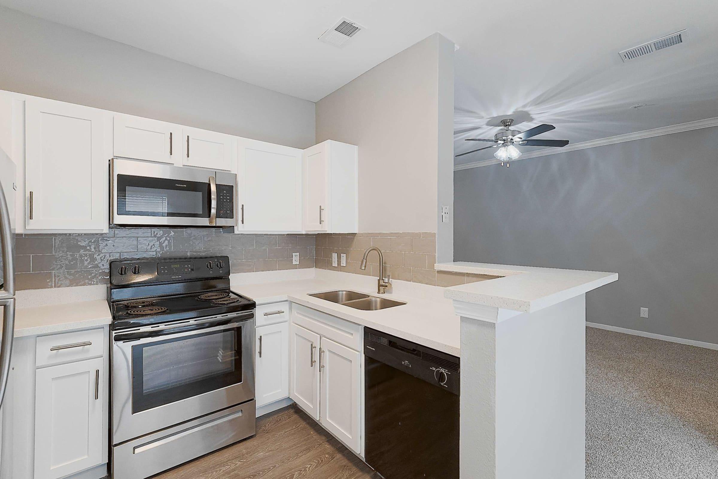 a stove top oven sitting inside of a kitchen