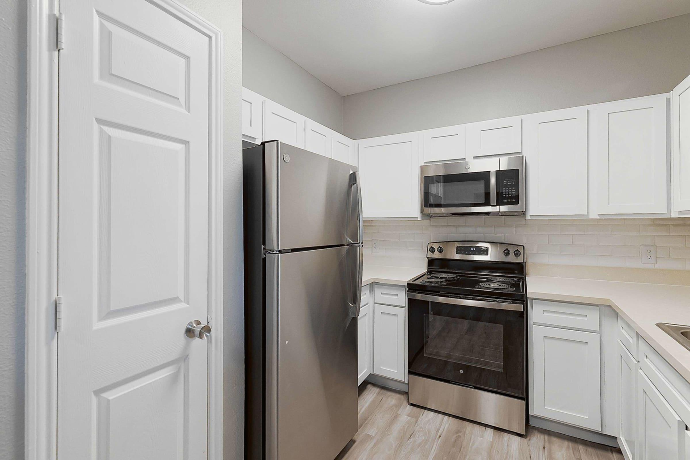 a kitchen with a stove sink and refrigerator