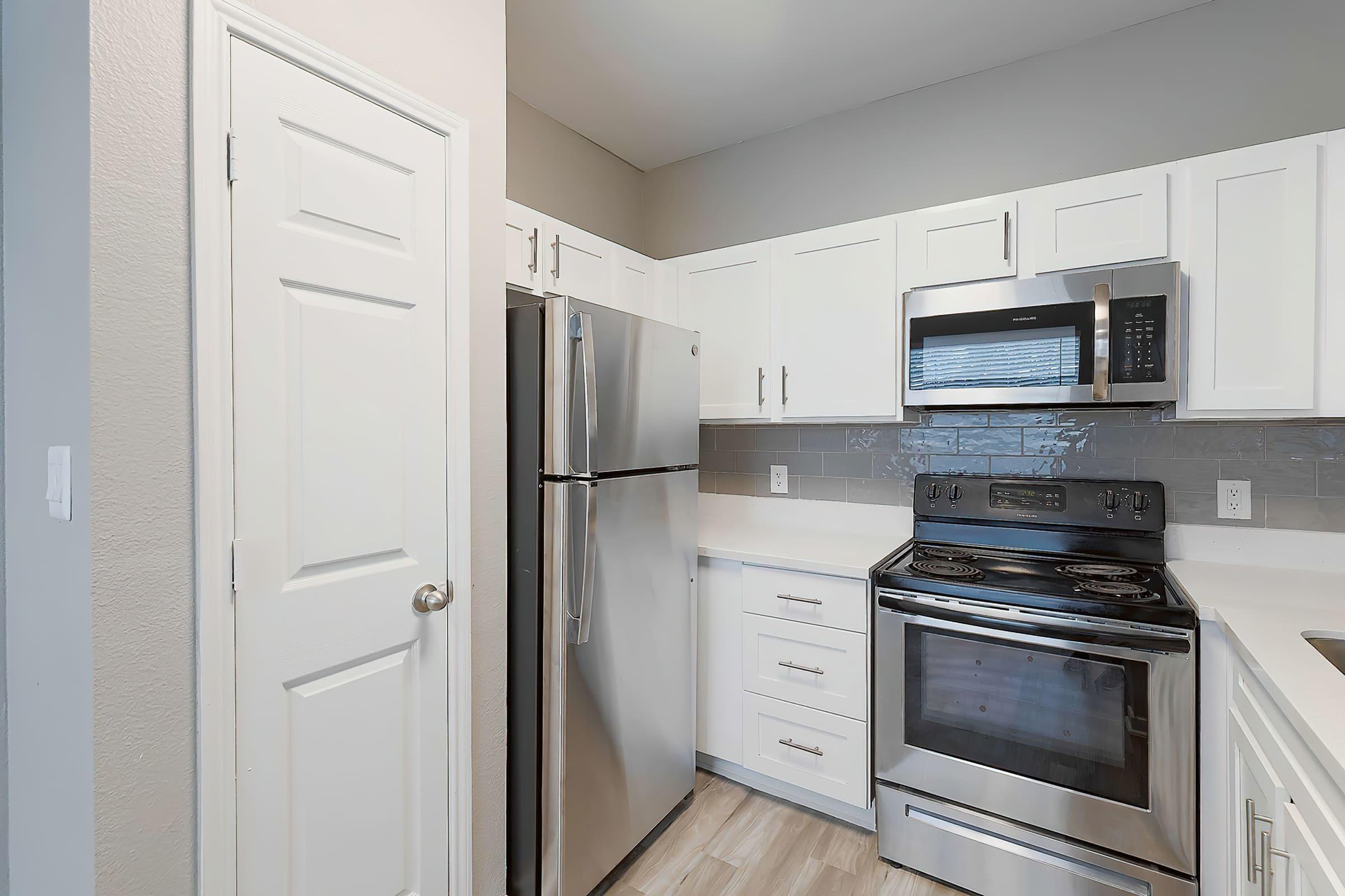 a stove top oven sitting inside of a kitchen