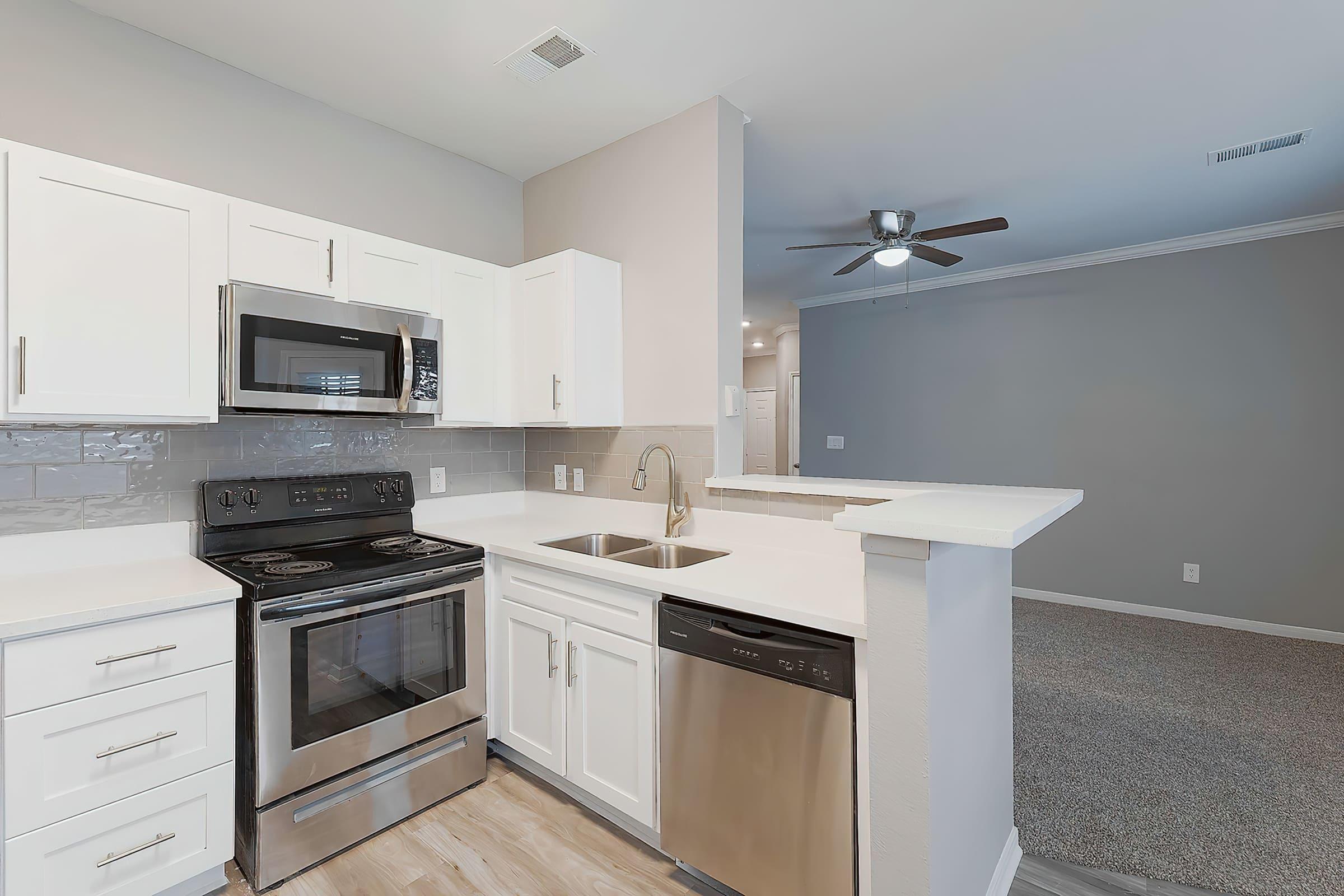 a stove top oven sitting inside of a kitchen