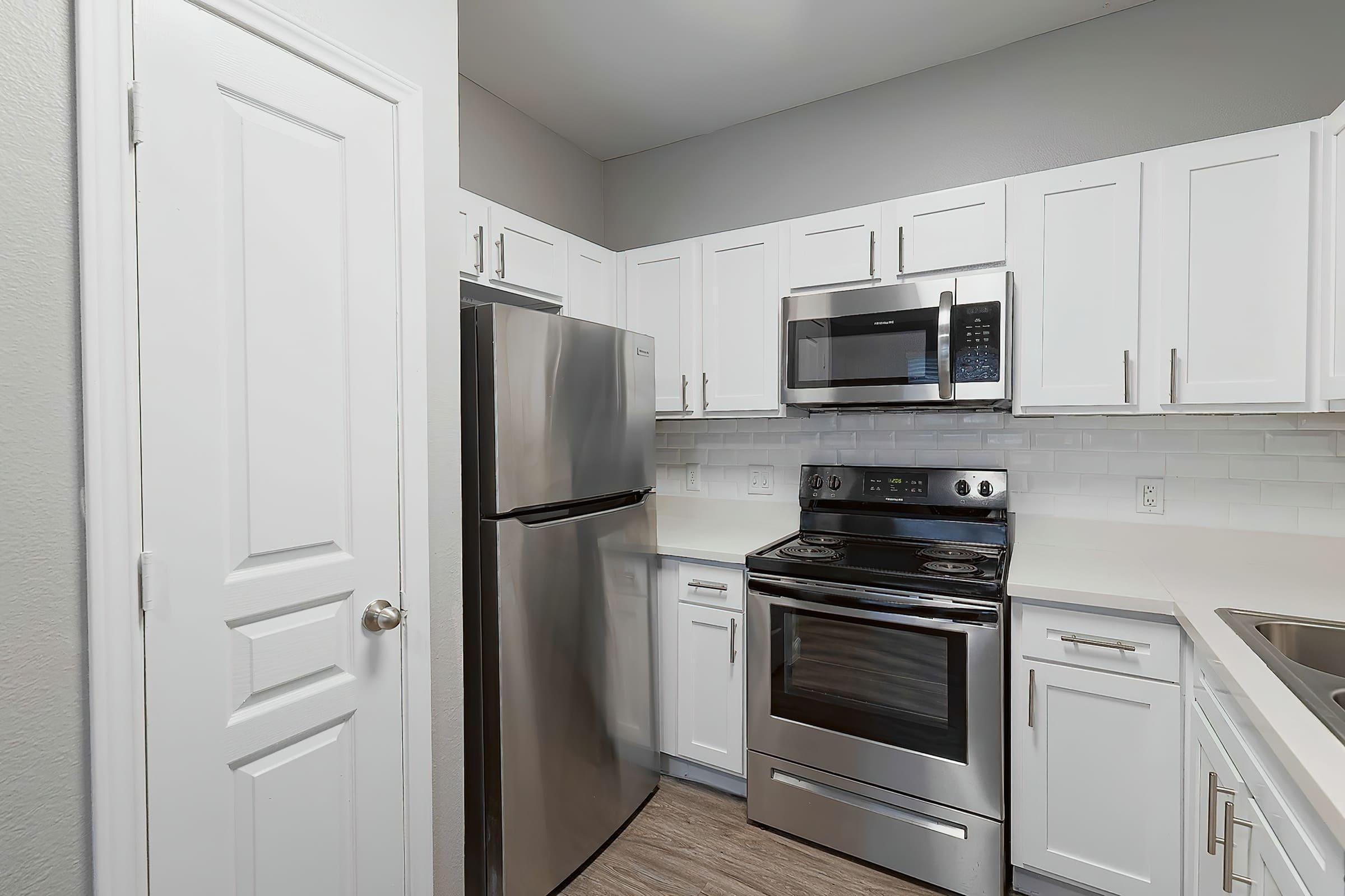 a stove top oven sitting inside of a kitchen