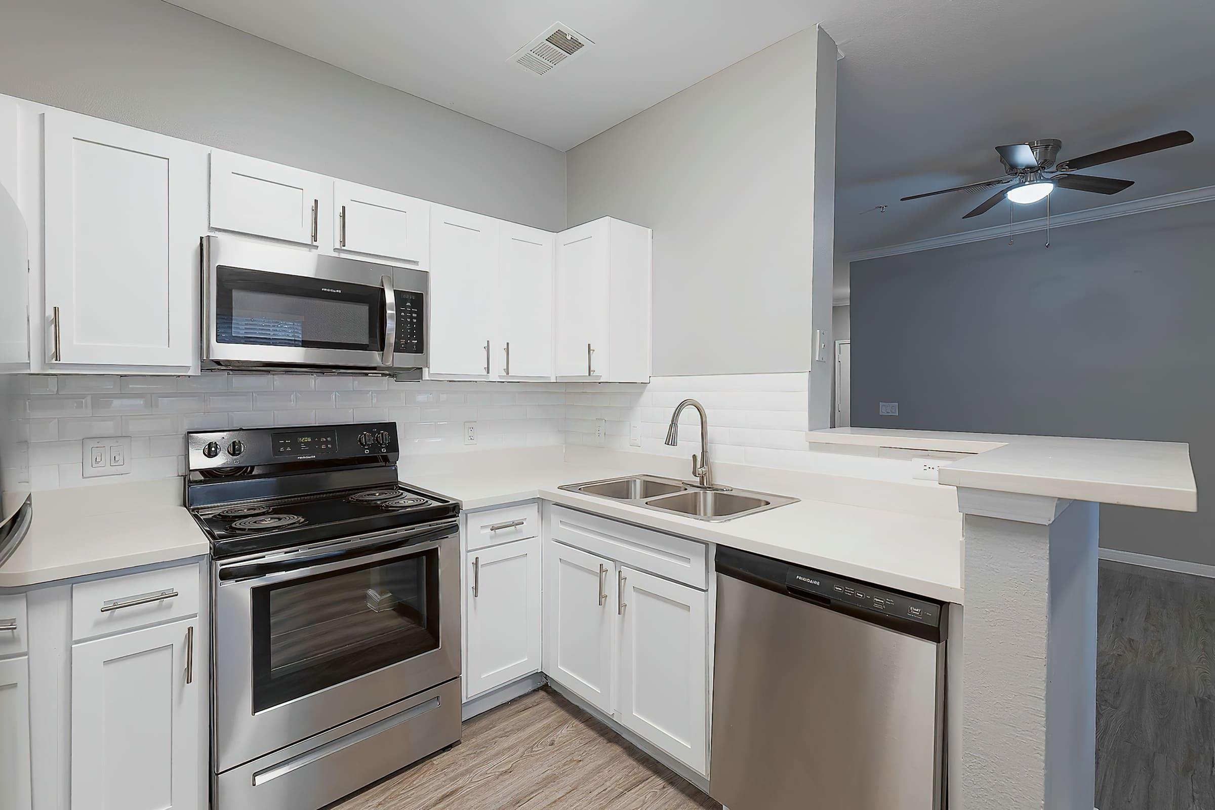 a stove top oven sitting inside of a kitchen