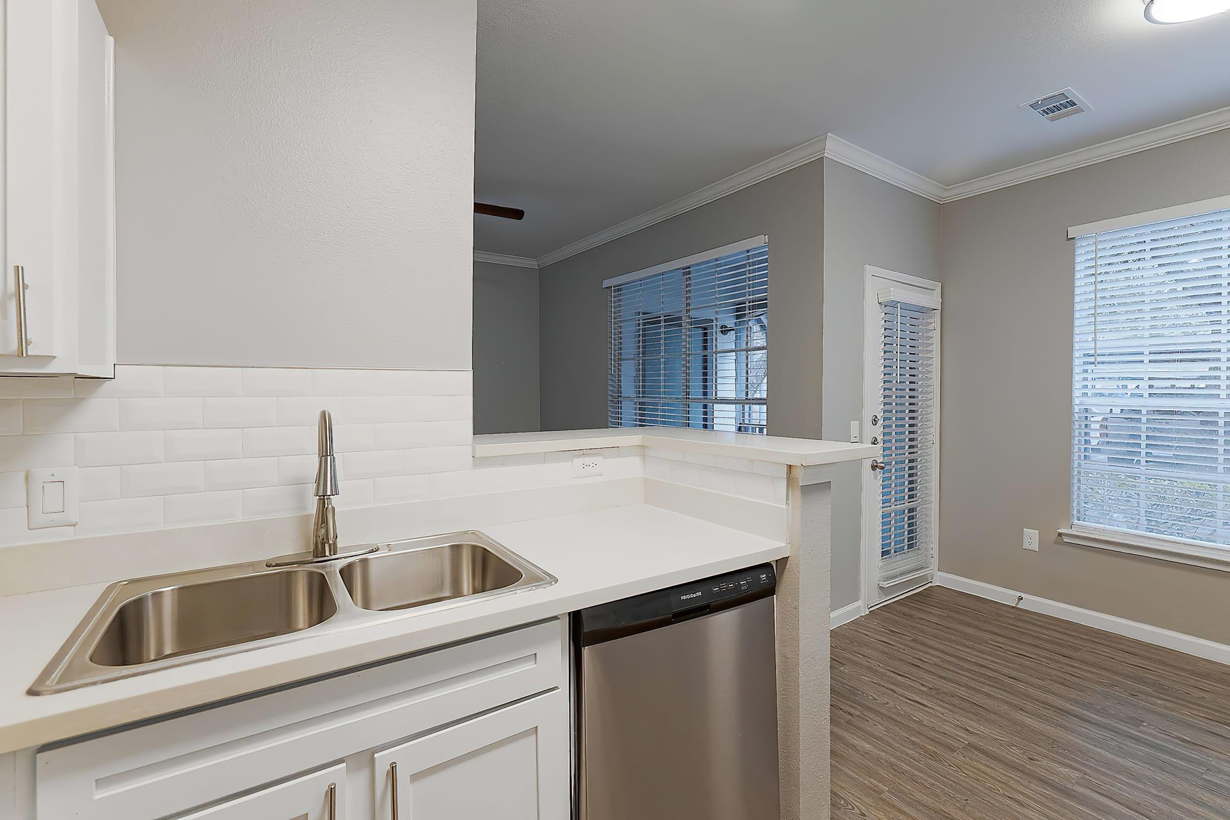 a kitchen with a sink and a window