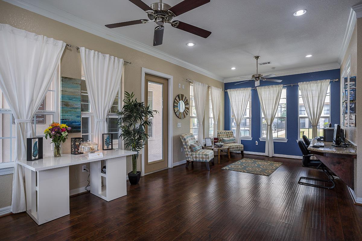 a living room filled with furniture and vase of flowers on a table