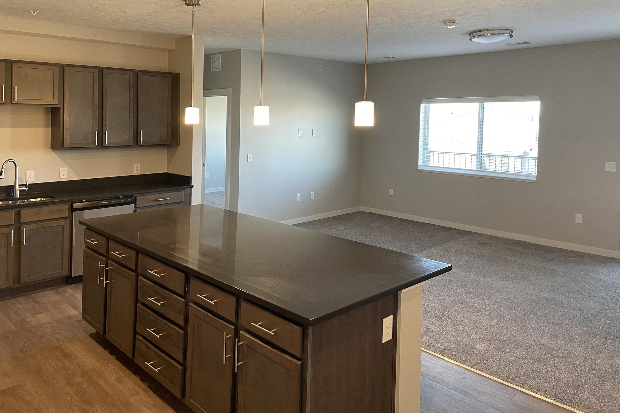 a modern kitchen with stainless steel appliances and wooden cabinets